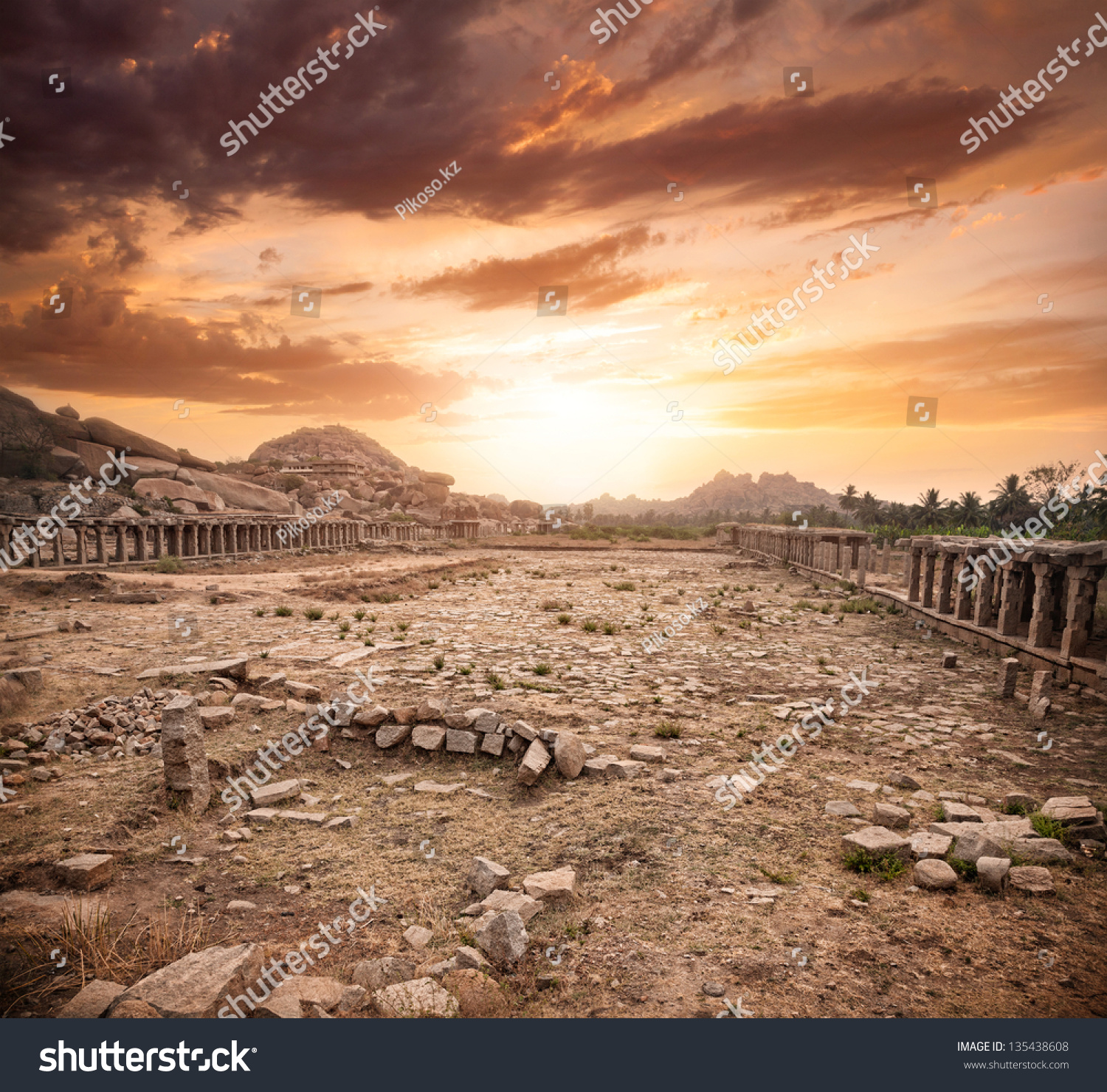Ancient ruins of Vijayanagara Empire at dramatic sky in Hampi, Karnataka, India #135438608