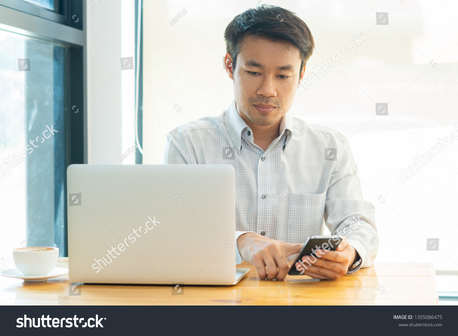 businessman working on a plan of Internet project on the laptop and working computer for internet research by smart phone. Digital marketing concept #1355086475