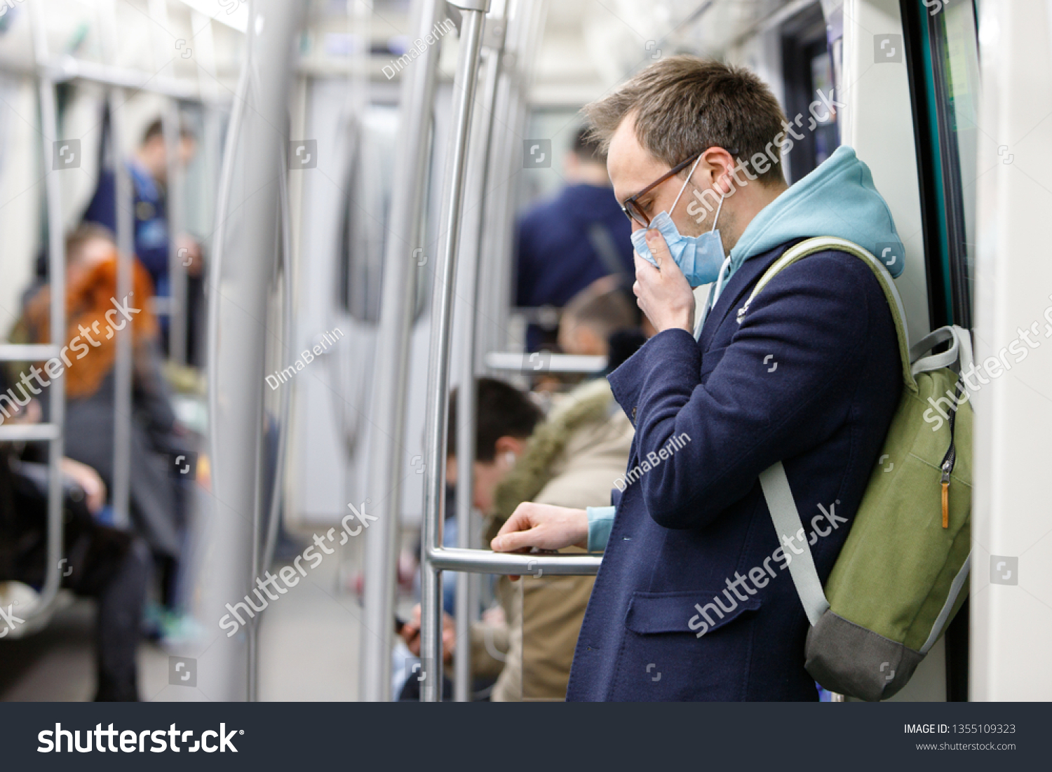 Ill man in glasses feeling sick, coughing, wearing protective mask against transmissible infectious diseases and as protection against the flu in public transport. New coronavirus 2019-nCoV from China #1355109323