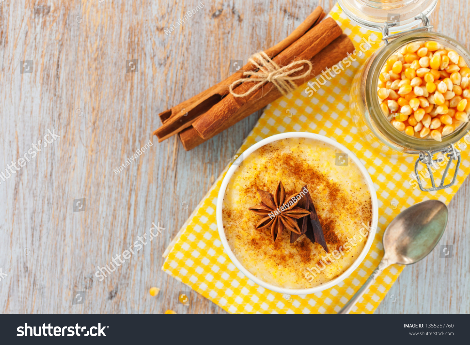 Brazilian sweet custard-like dessert curau de milho mousse of corn with cinnamonon a light background. Corn porridge with cinnamon in a bowl. Top view #1355257760