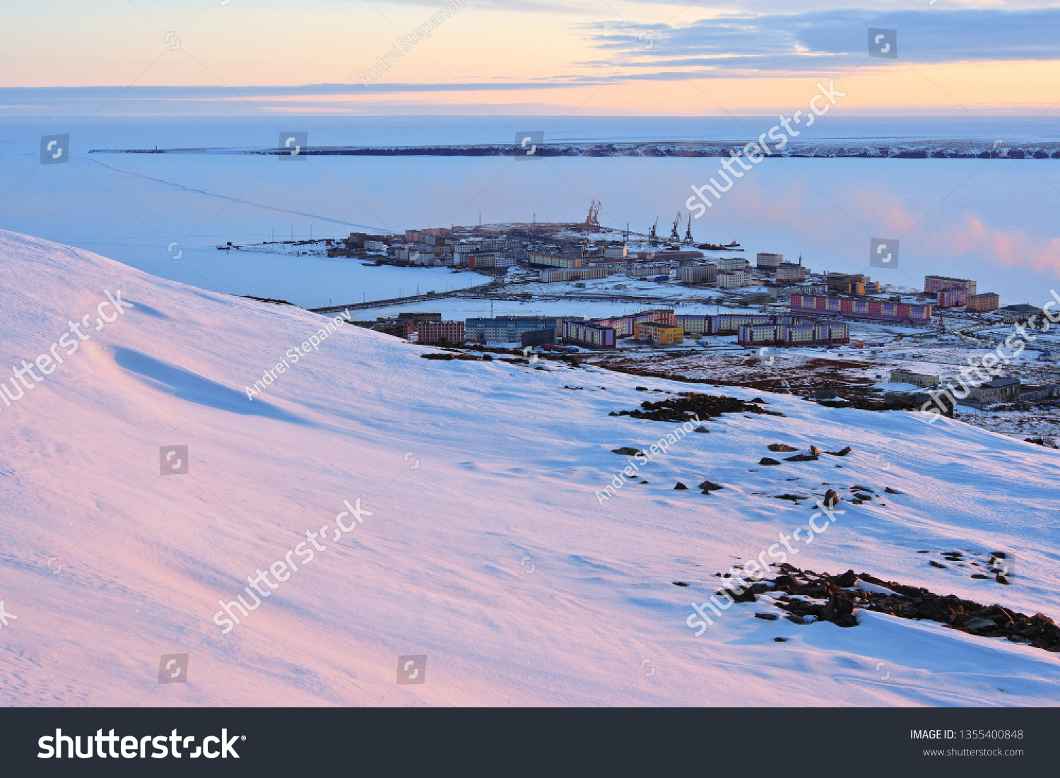 Arctic settlement. Pevek is the northernmost city in Russia. Cold snowy May in the Arctic in the north of Chukotka. Small polar town and the coast of the Arctic Ocean. Pevek, Chukotka, Siberia, Russia #1355400848