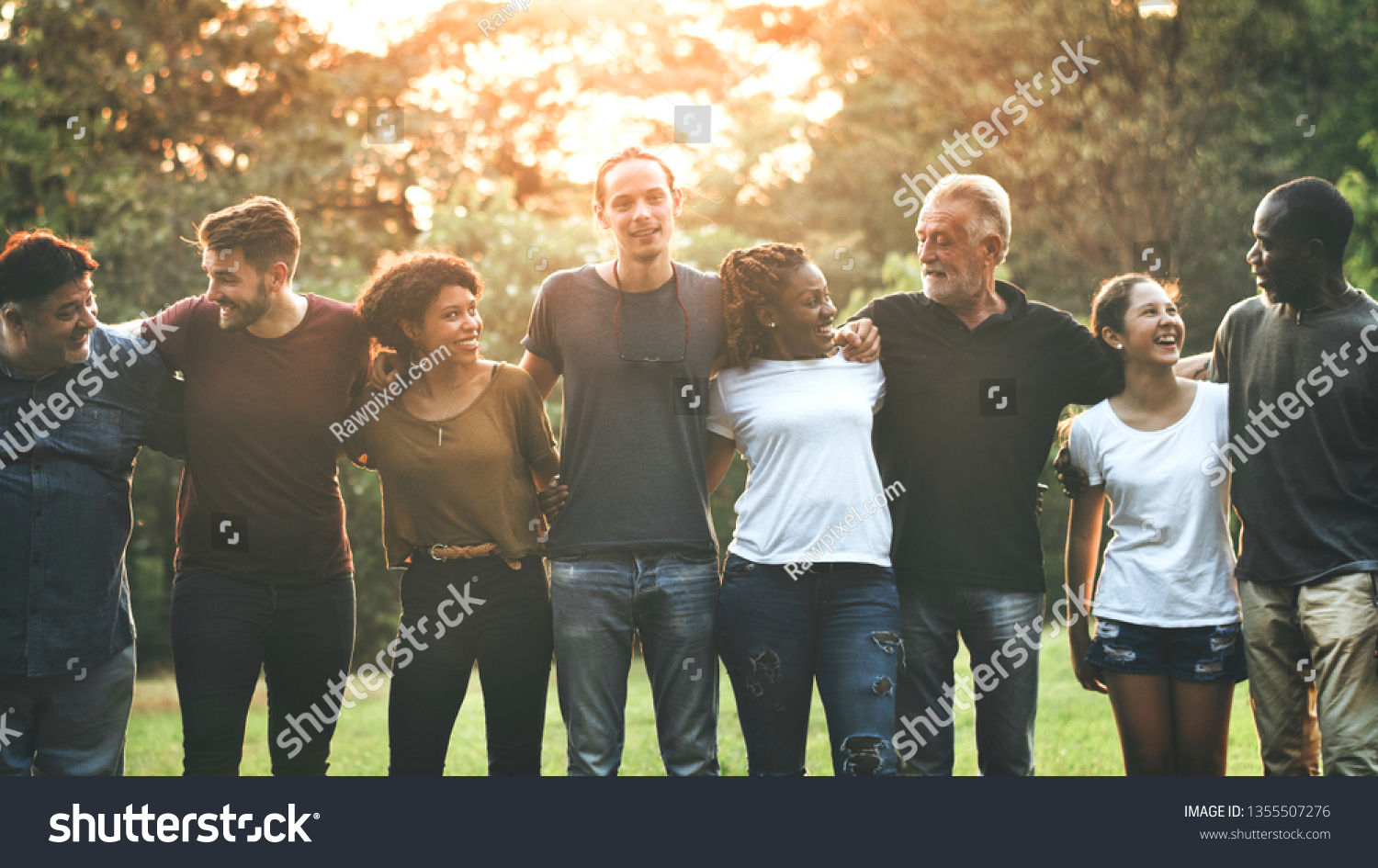 Cheerful diverse people huddling in the park #1355507276