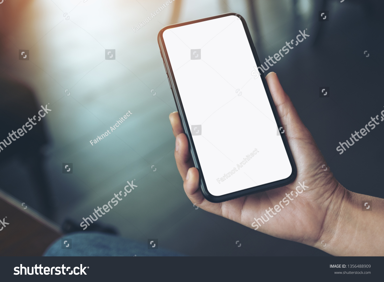 Mockup image of a woman's hand holding black mobile phone with blank desktop screen  #1356488909