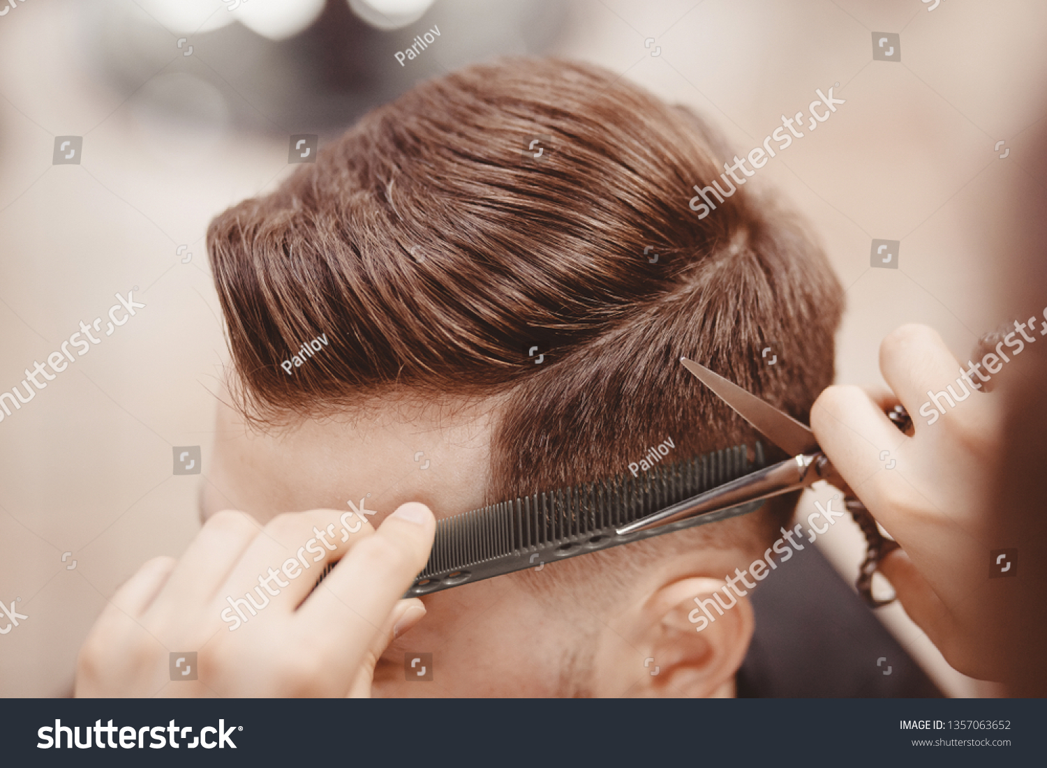 Close-up, master hairdresser does hairstyle with scissors comb. Concept Barbershop. #1357063652