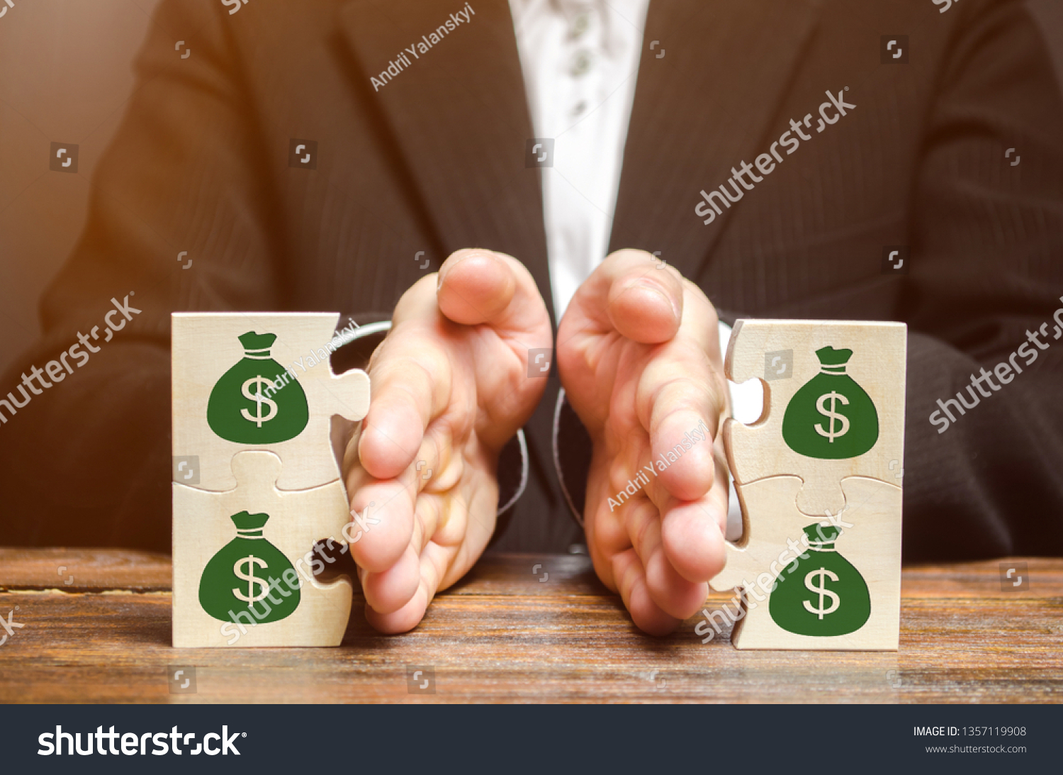 Businessman separates the wooden puzzle with a picture of money. The concept of financial management and distribution of funds. Saving and investing. Property division. Divorce and legal services #1357119908
