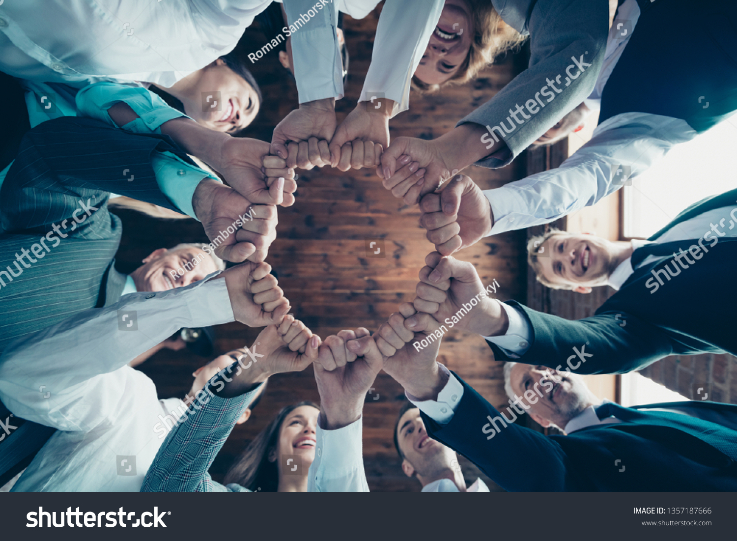 Close up low angle view photo members business people circle she her he him his hold hands arms fists together celebrate project prize nomination power inspiration dressed formal wear jackets shirts #1357187666
