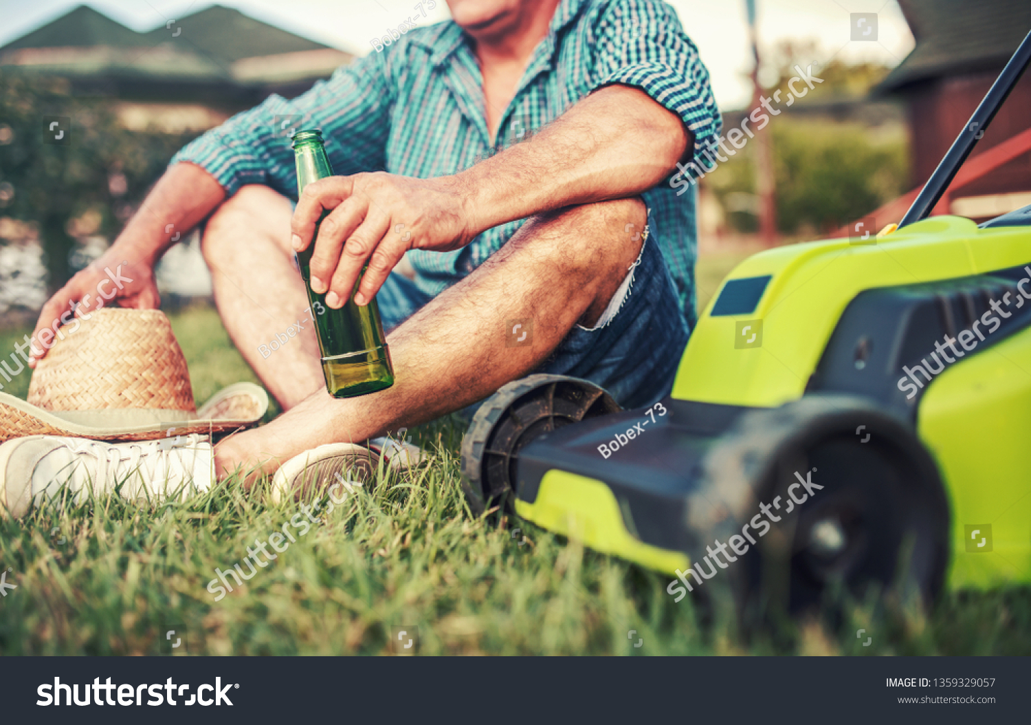 Gardening. Senior man take a rest in the yard and enjoying in beer after work with a lawn mower. Hobbies and leisure #1359329057