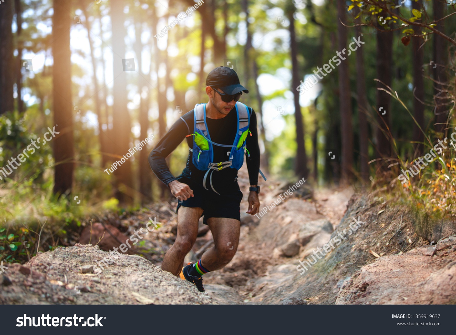 A man Runner of Trail . and athlete's feet wearing sports shoes for trail running in the forest #1359919637