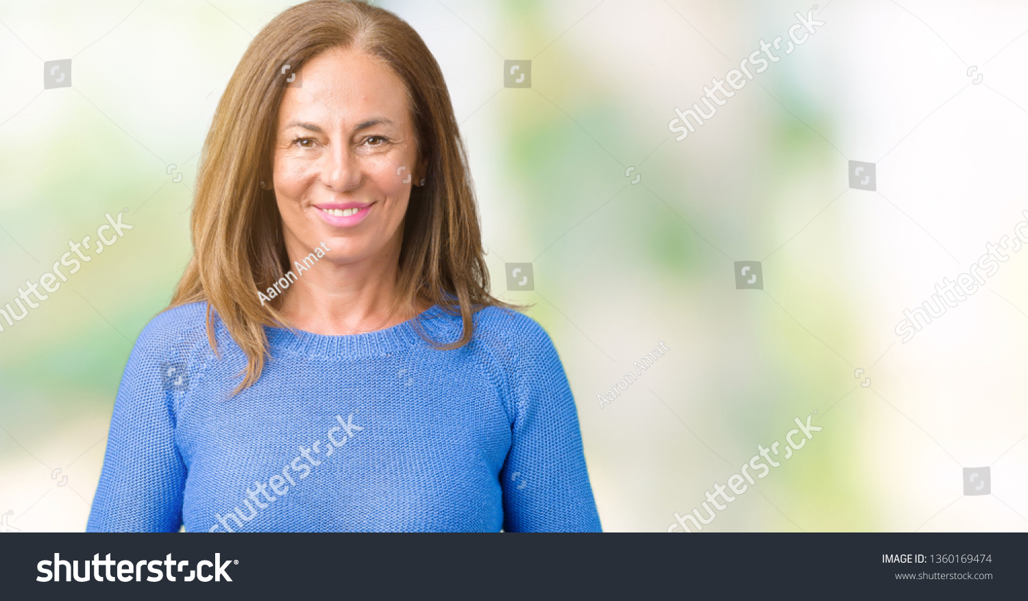 Middle age beautiful woman wearing winter sweater over isolated background Hands together and fingers crossed smiling relaxed and cheerful. Success and optimistic #1360169474