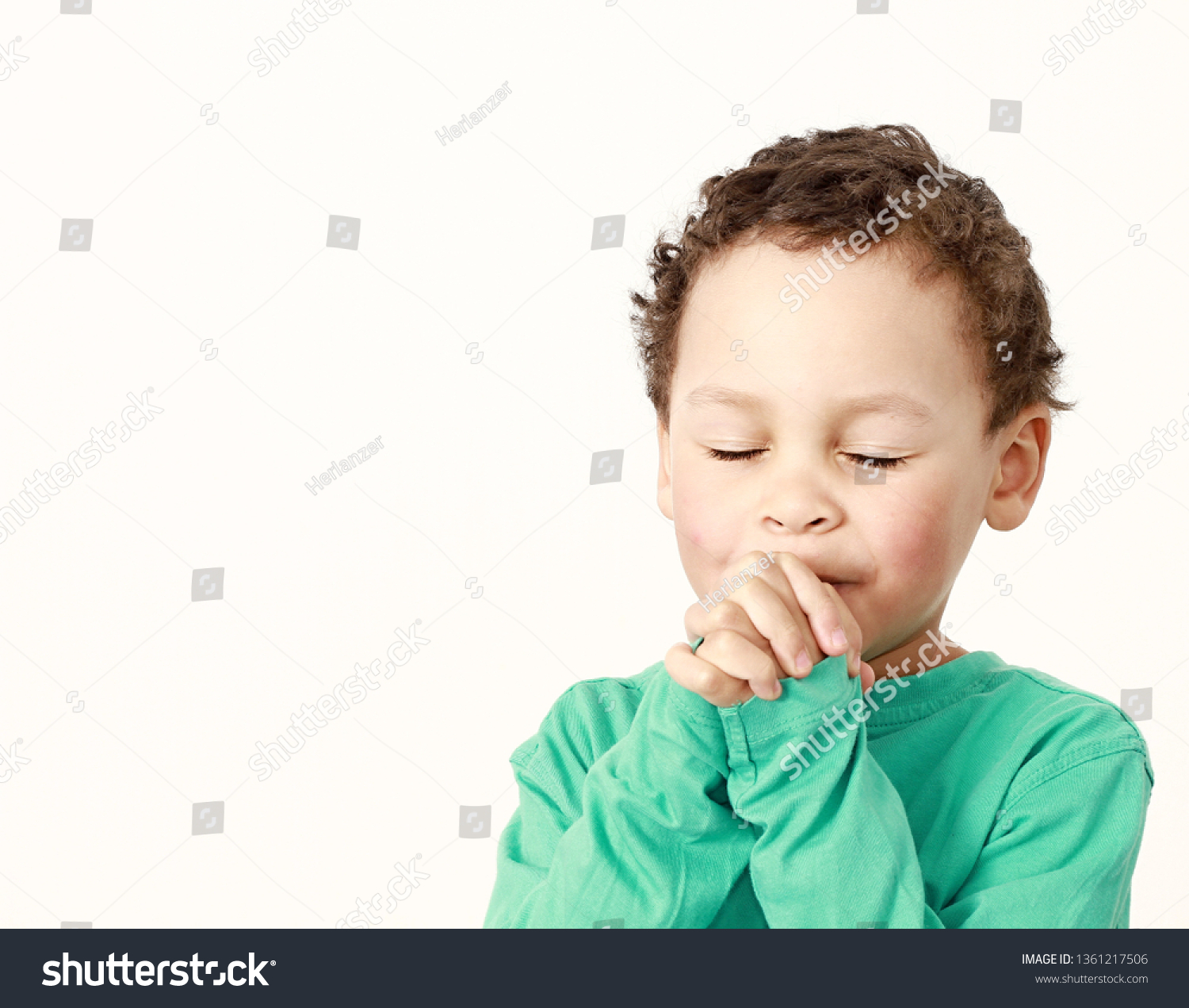 child praying to God with hands held together and head bowed low on white background stock image and stock photo #1361217506
