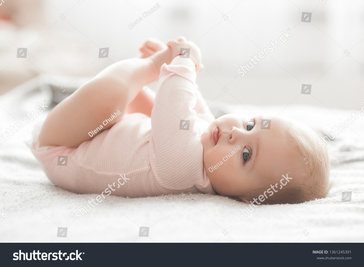Adorable little baby portrait. Cute baby girl indoor. 6 month child smiling. #1361245391