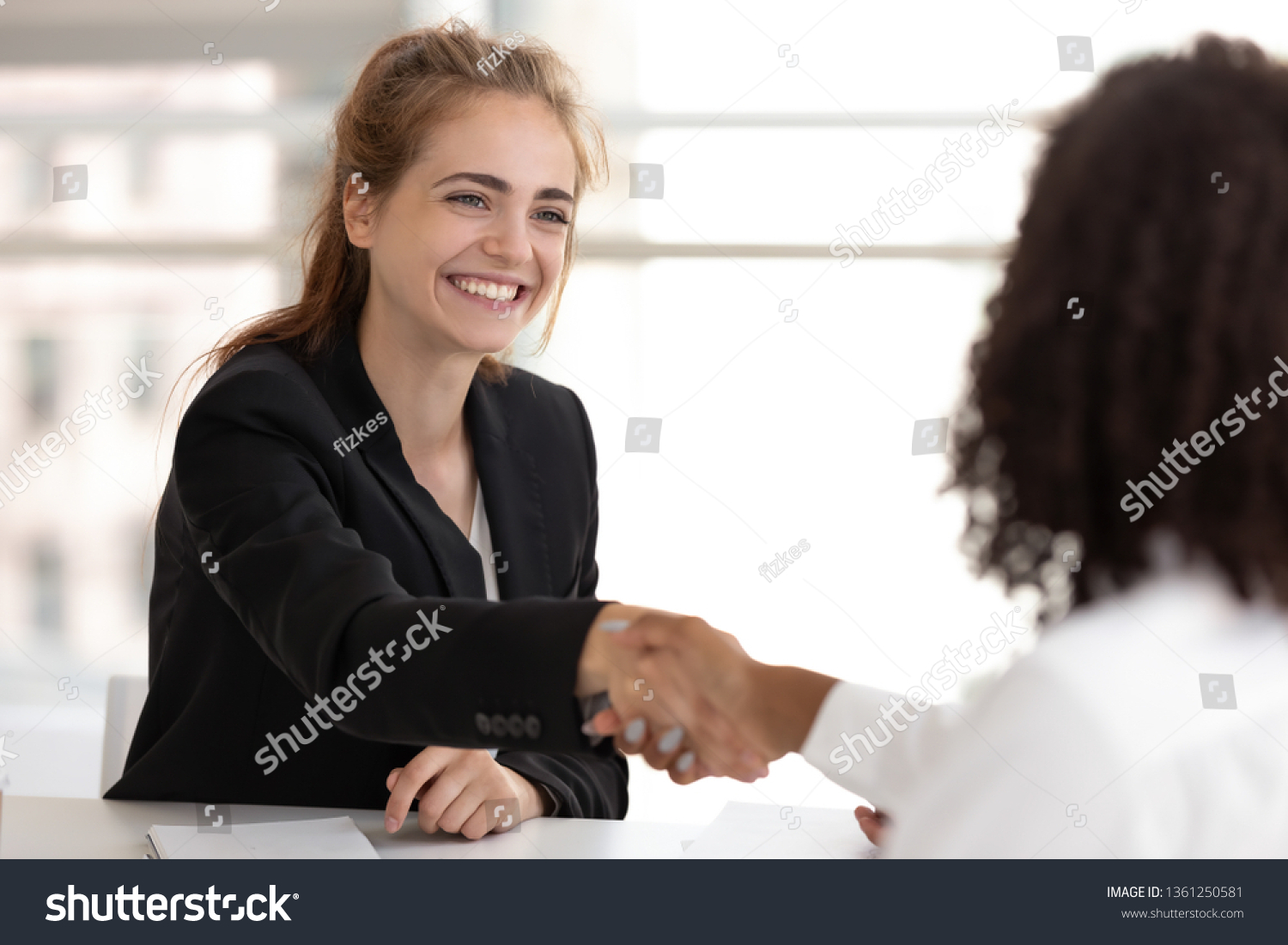Happy businesswoman hr manager handshake hire candidate selling insurance services making good first impression, diverse broker and client customer shake hand at business office meeting job interview #1361250581