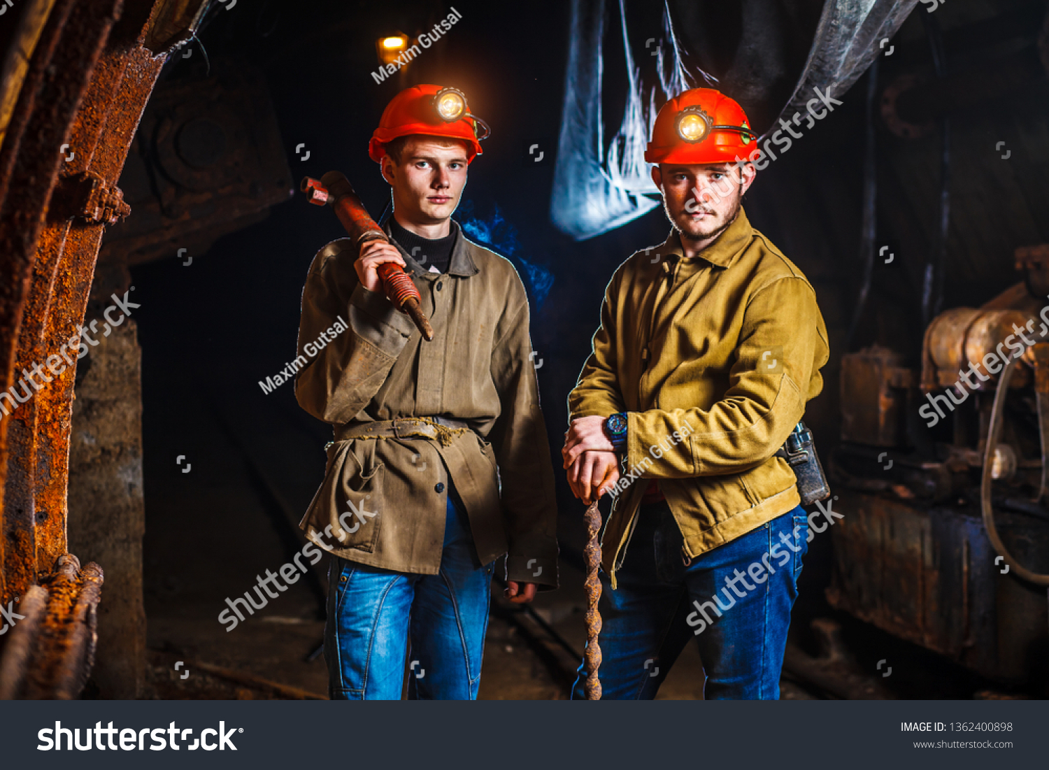 Miners in the process of working with tools in their hands. Coal mine. Two miners in the mine. Copy Space #1362400898