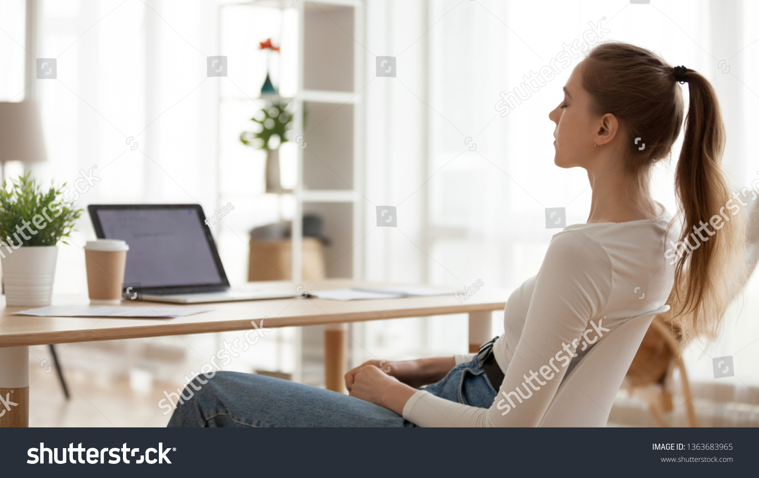 Calm peaceful young woman relaxing in office chair at workplace, tired employee sitting at desk, female student taking break after study, meditating with closed eyes, breathing deep, thinking #1363683965
