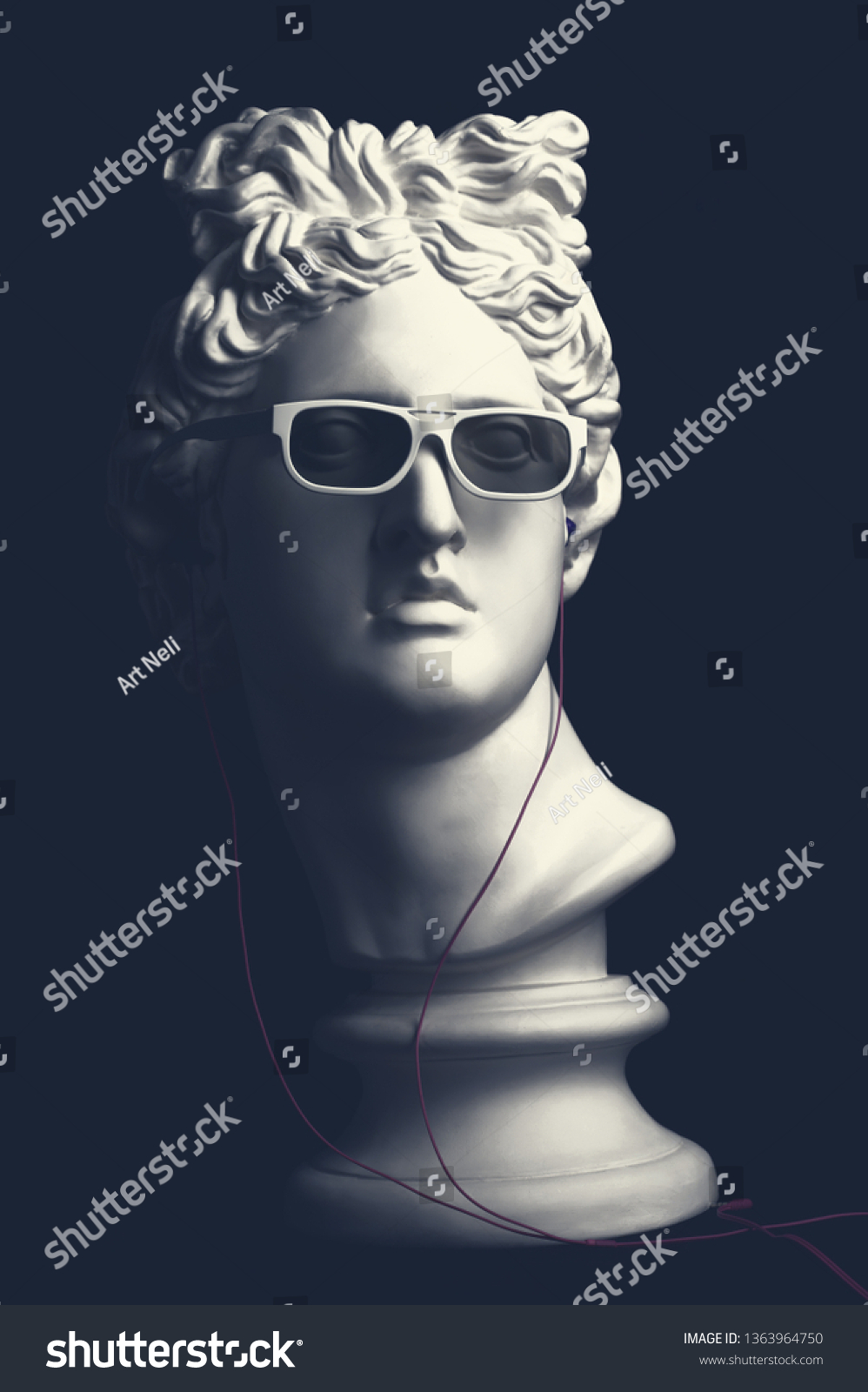 Statue. Earphone. Isolated. Gypsum statue of Apollo's head. Man. Creative. Plaster statue of Apollo's head in earphones and white sunglasses. Apollo Belvedere. Artwork #1363964750