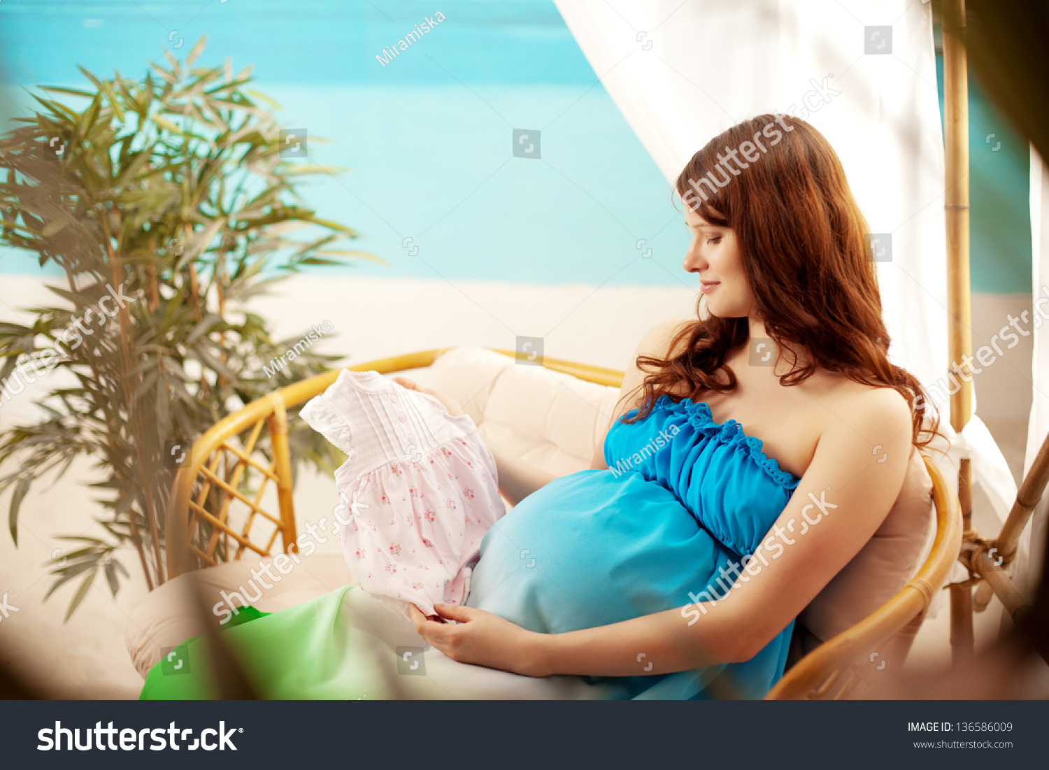 Beautiful pregnant woman on the beach in bungalow #136586009