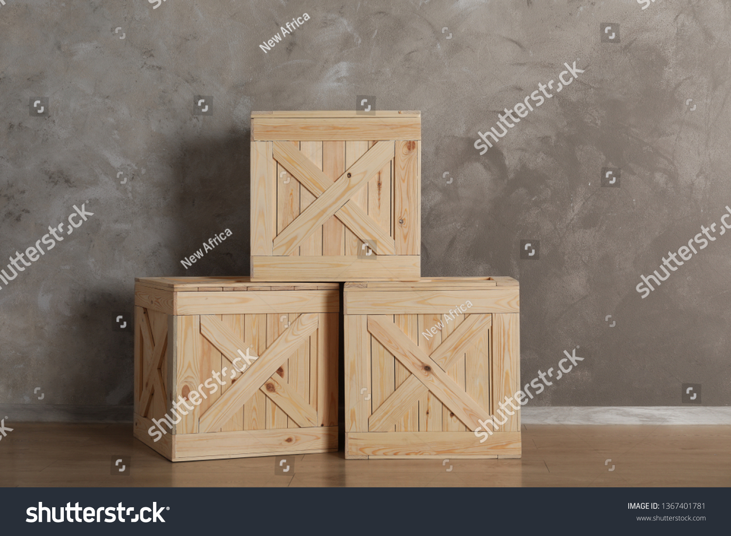 Wooden crates on floor against color background, space for text #1367401781