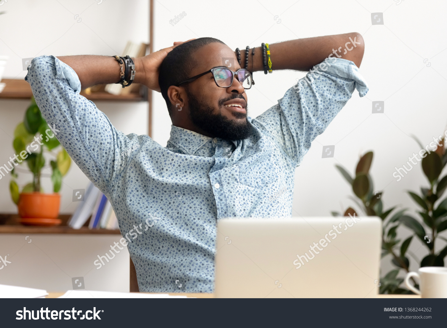 Calm african american business man take break at workplace relaxing finished work, happy black professional employee enjoy success rest from computer feeling stress relief peace of mind sit at desk #1368244262