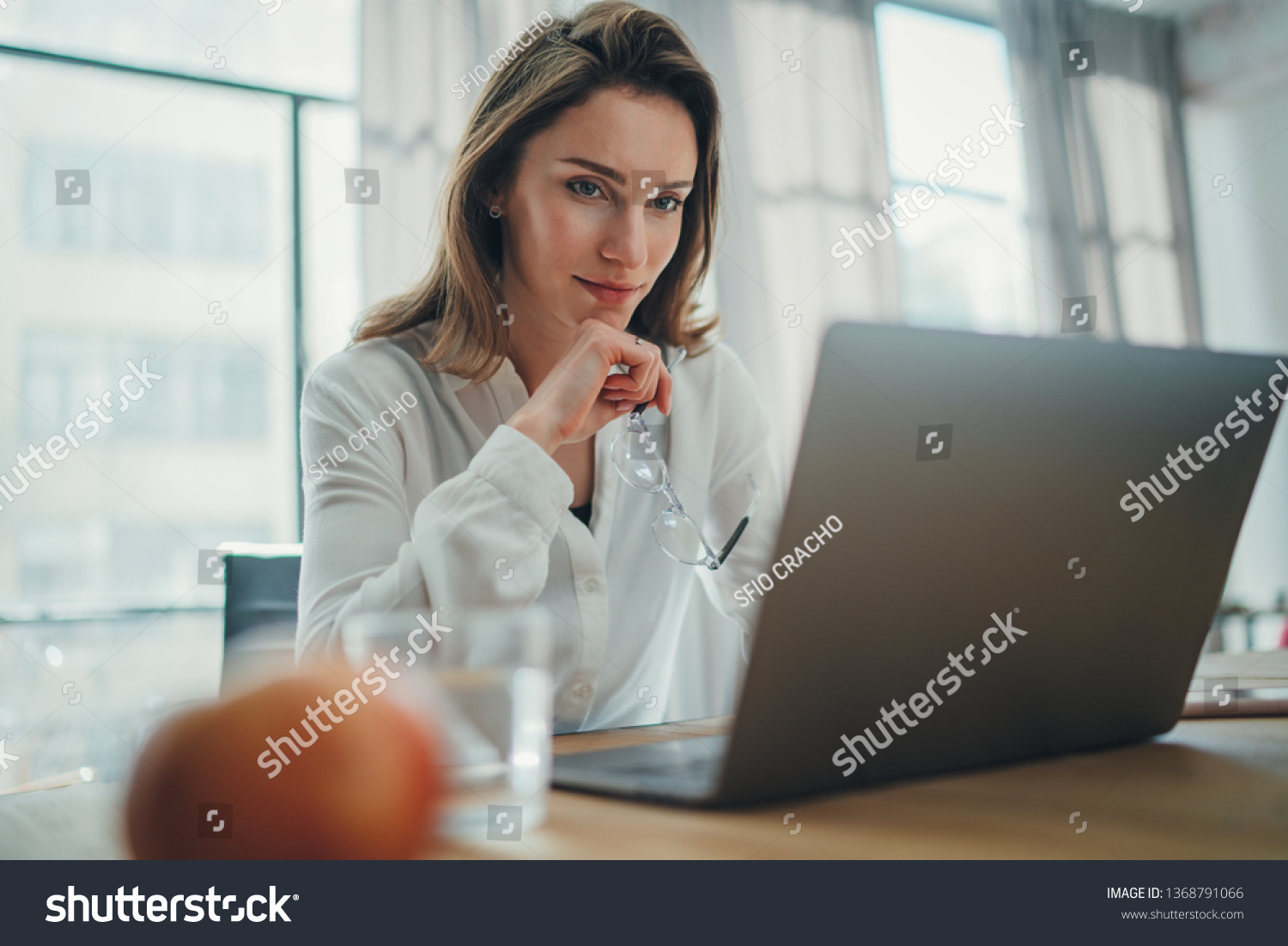 Handsome businesswoman working on laptop at her workplace at modern office.Blurred background #1368791066