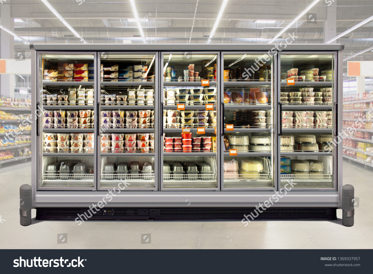 Ice cream and birthday cakes in a glass door freezer at supermarket. Suitable for presenting new packaging among many others. Front view. #1369337957