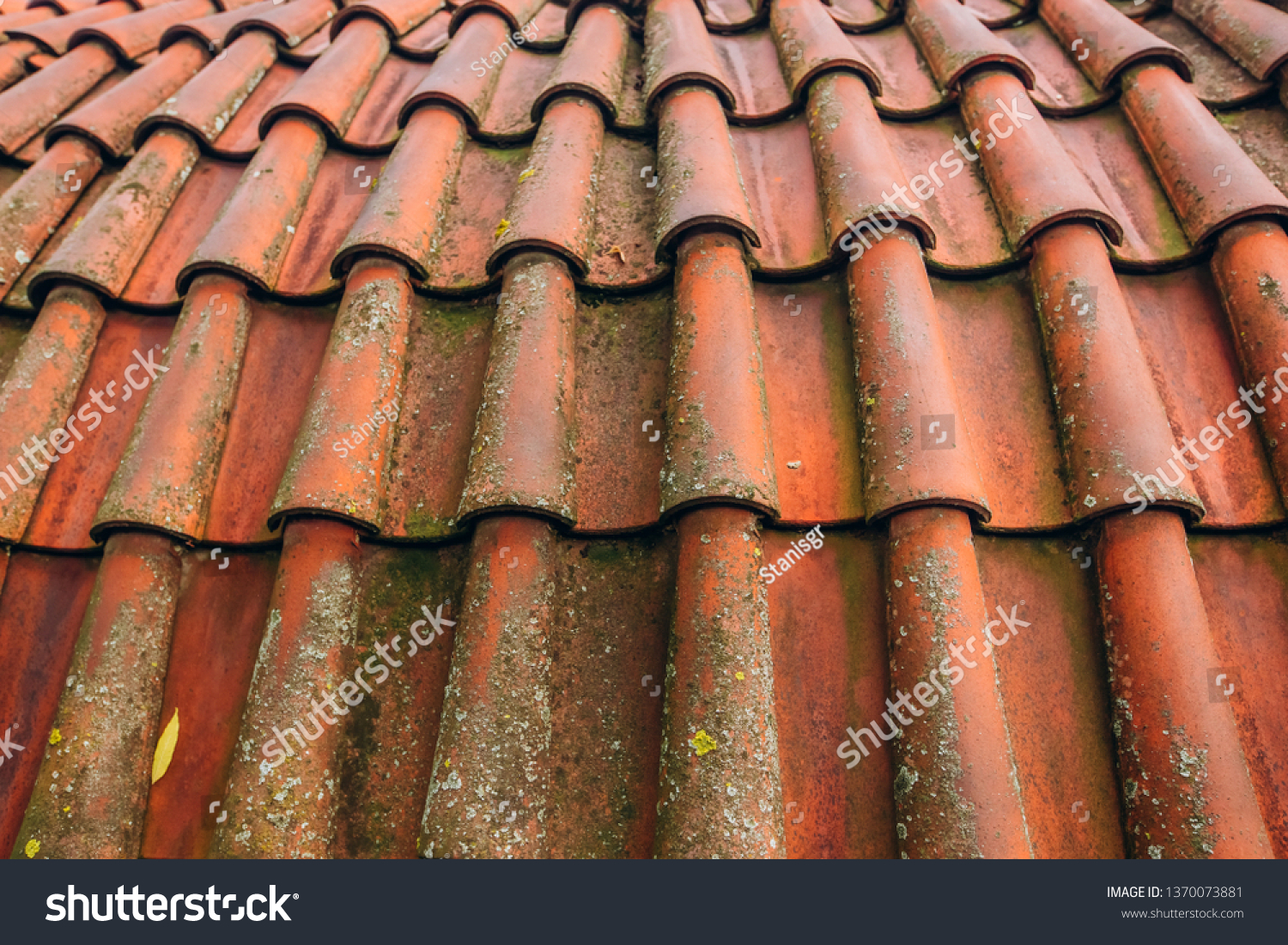 Exterior of brick house with red roof tiles, Prague. Retro red tile roof of old house #1370073881