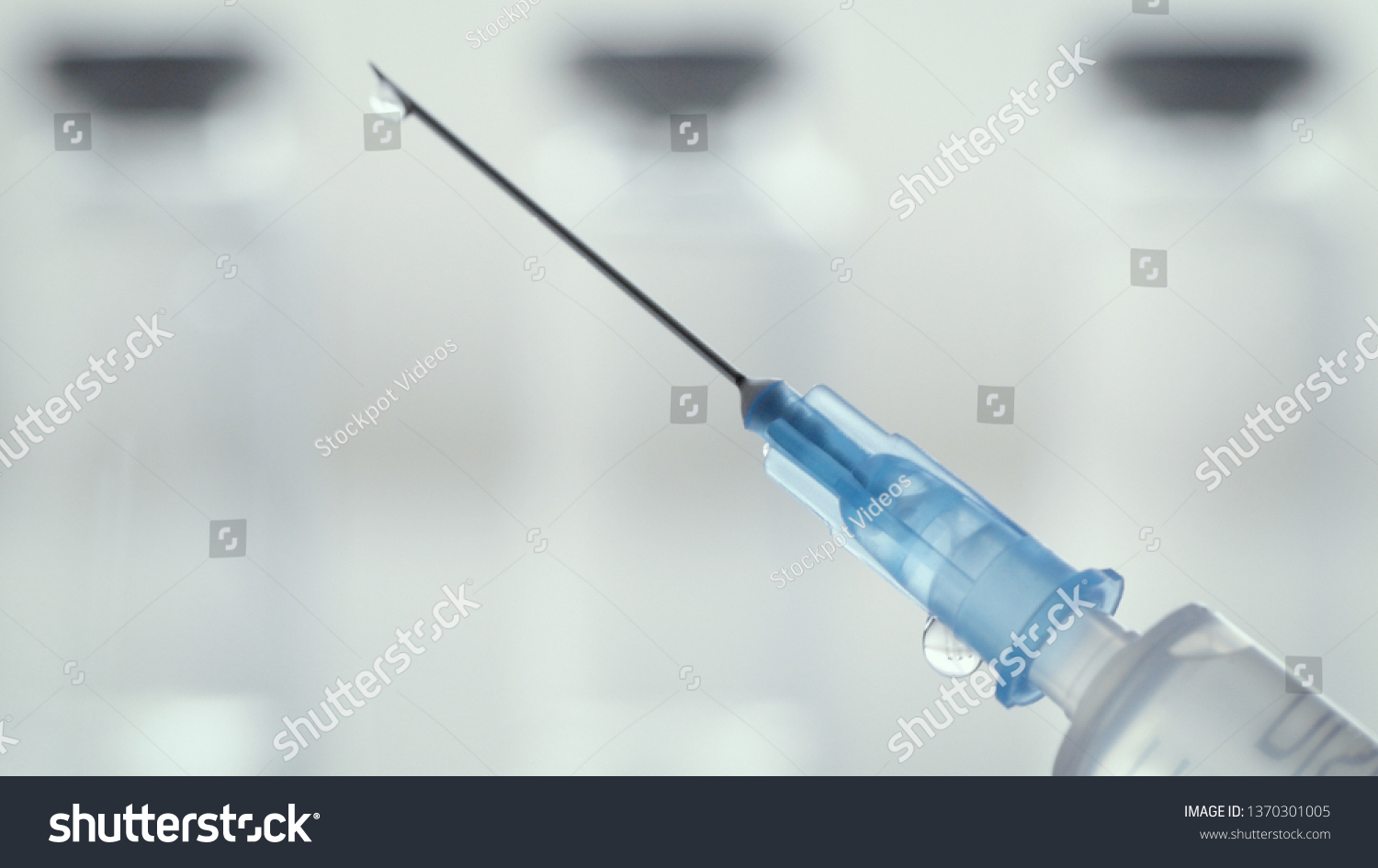Measles vaccine shooting from a plastic syringe. Mandatory vaccinations are currently a hotly debated topic with the anti-vaxx movement believing vaccines cause autism. #1370301005