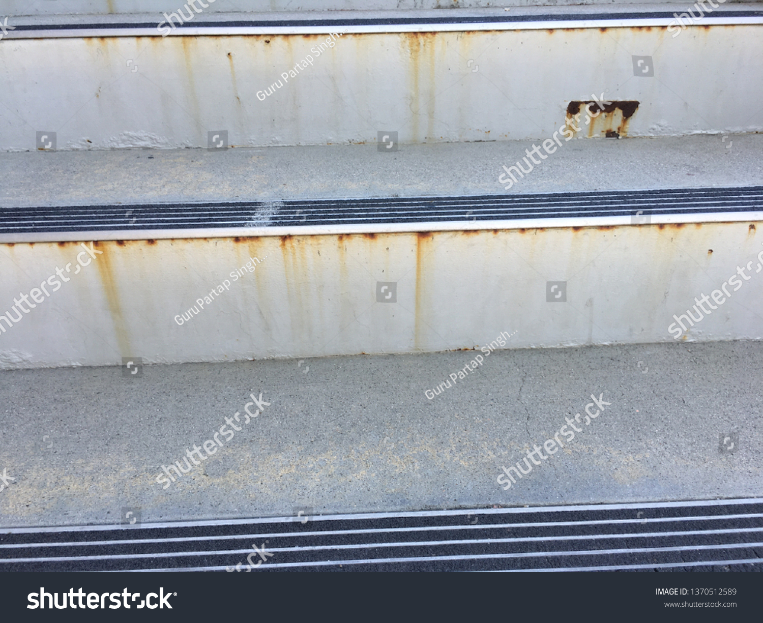 Closeup of rusting metal stairs. #1370512589