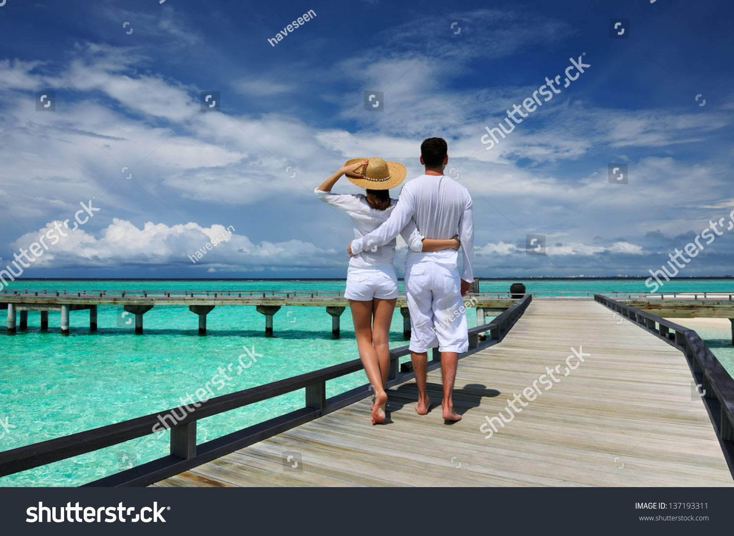 Couple on a tropical beach jetty at Maldives #137193311