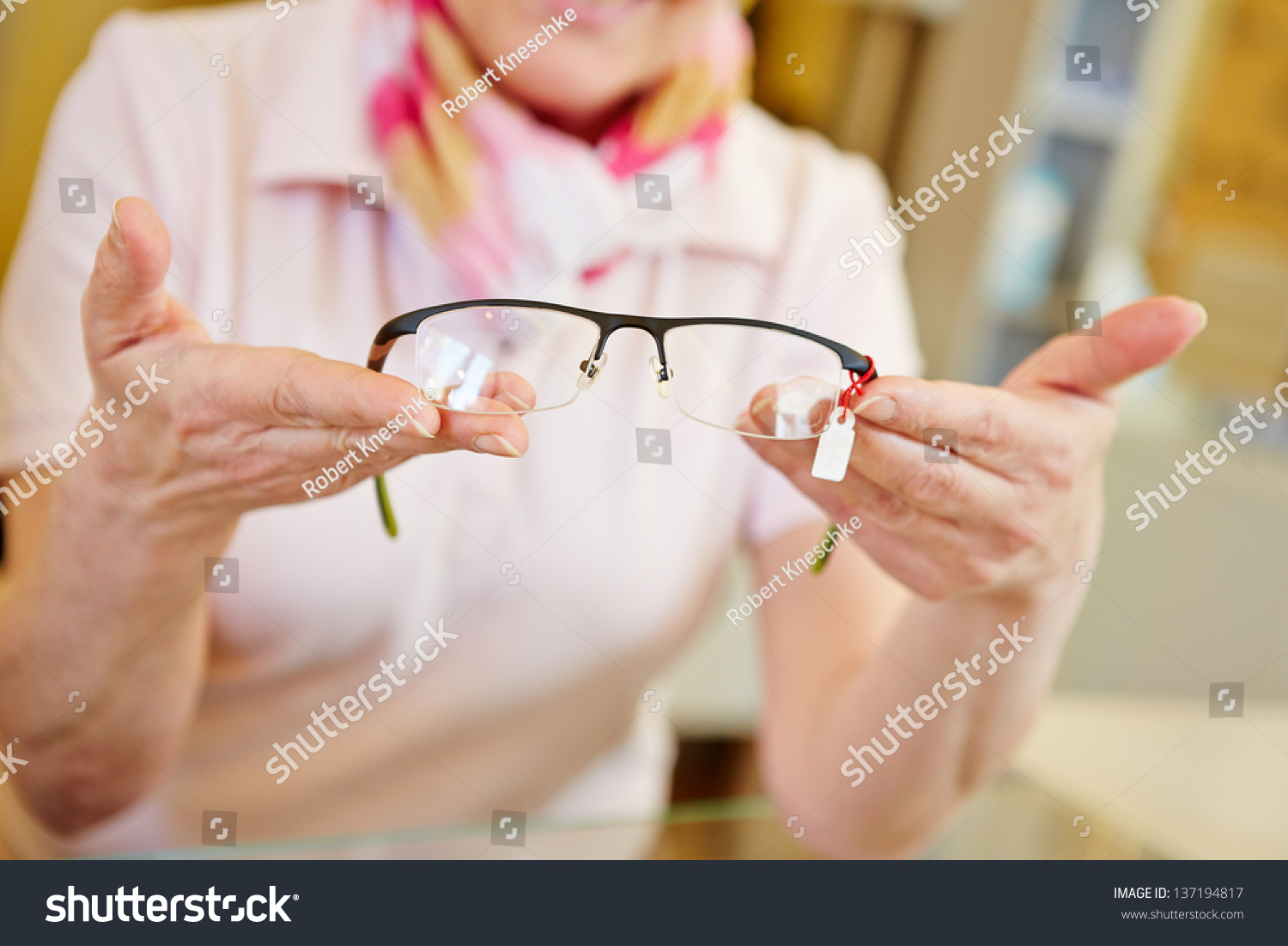 Hands of optician offering new fashionable glasses #137194817