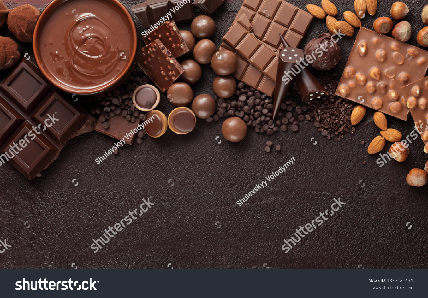 Chocolate candy box / Assortment of fine chocolates in white, dark, and milk chocolate and a bowl of melted chocolate #1372221434