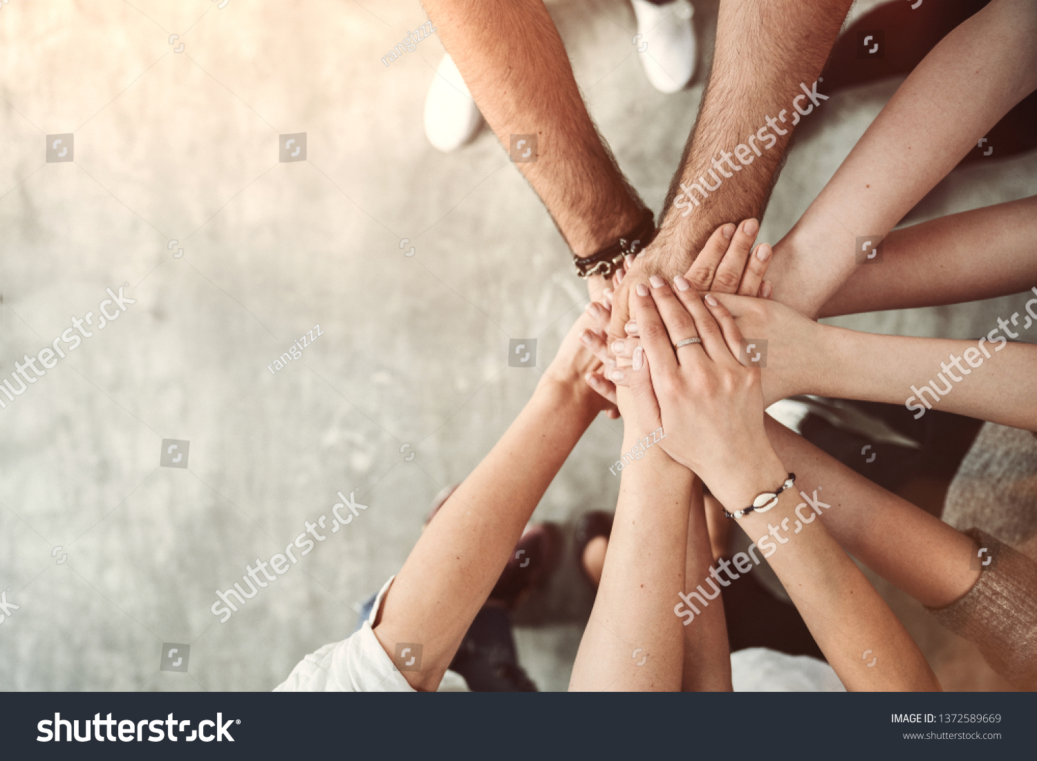 Teamwork, unity concept, group of friends put their hands together with copy space #1372589669