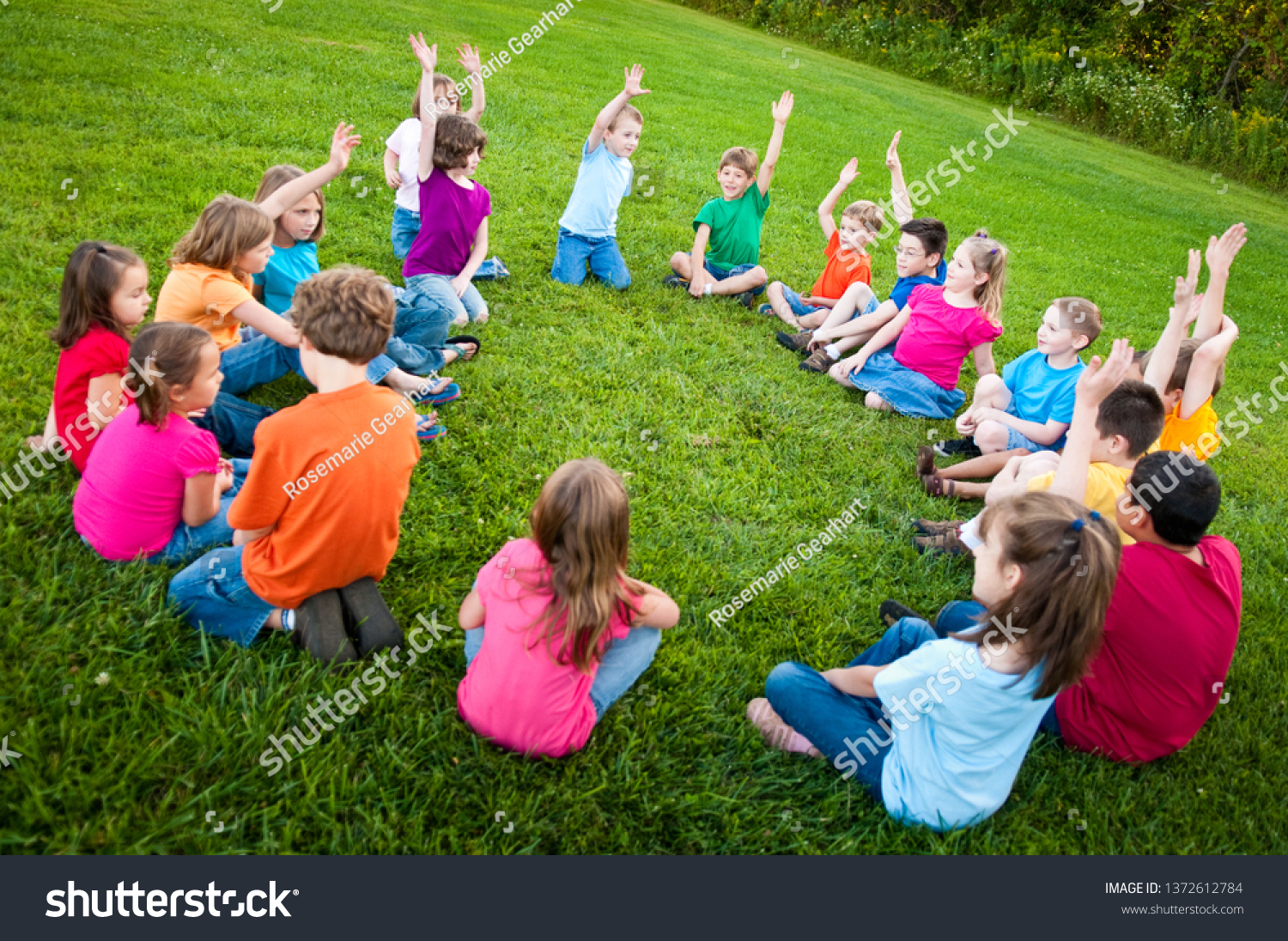 Group of Kids Sitting in a Circle Outside #1372612784
