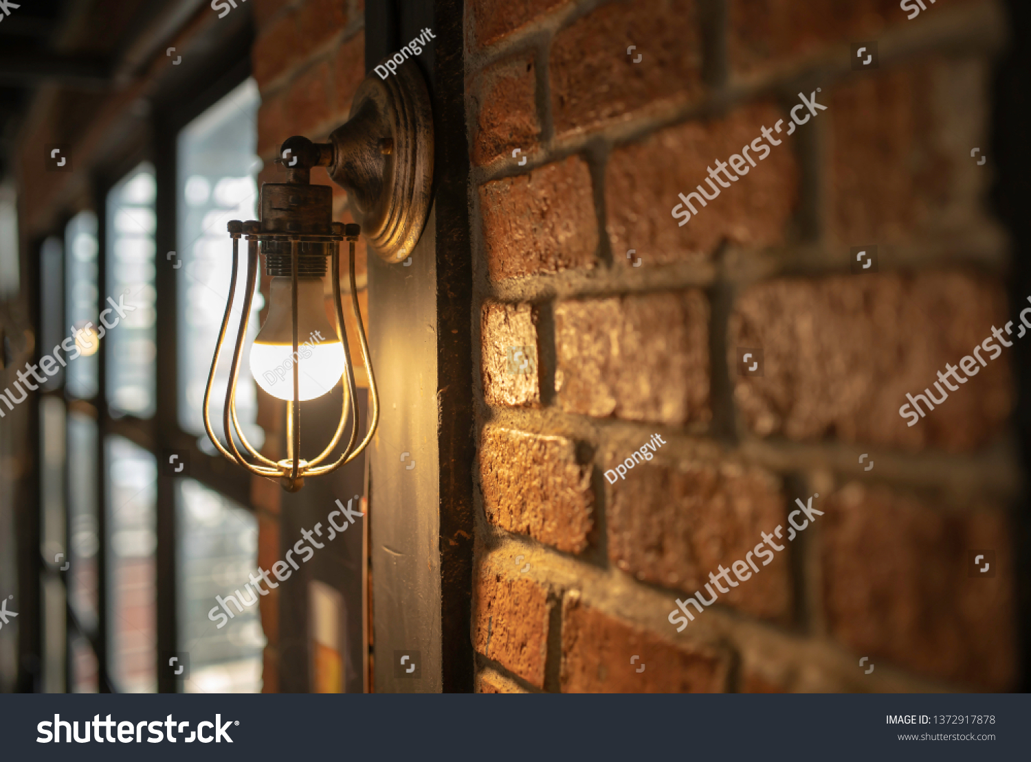 Antique electronic lamp, red wall lamp, high wall lamp, soft light.Red brick wall.Open chain, turn off the lights.hanging at the red brick wall in the building,Wall light brown brick,soft focus. #1372917878