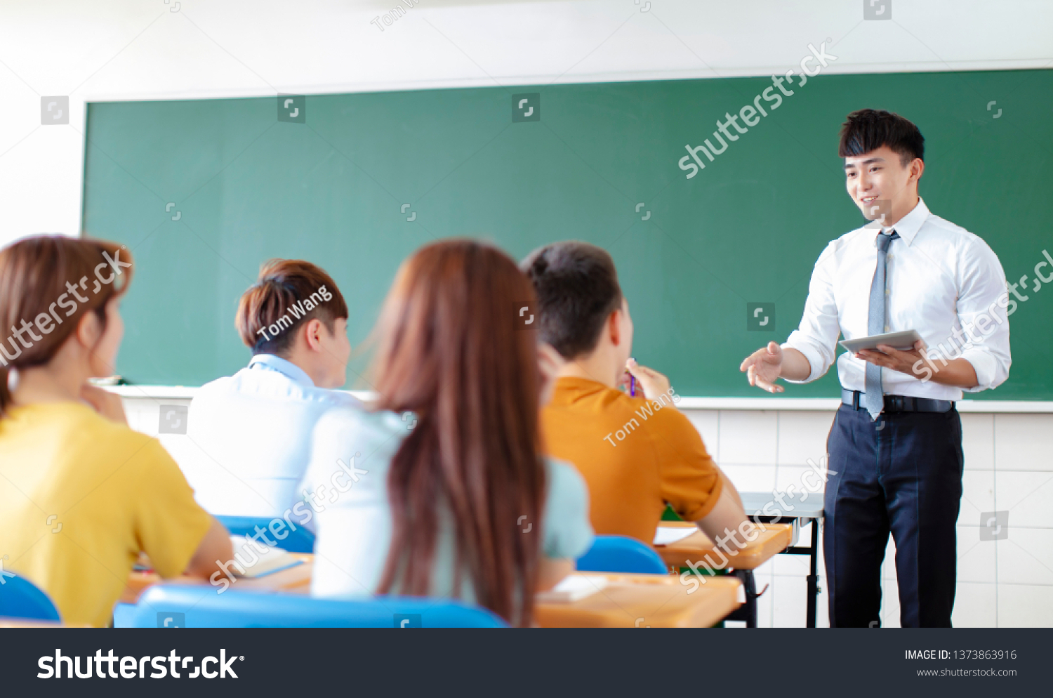 teacher with group of college students in classroom #1373863916