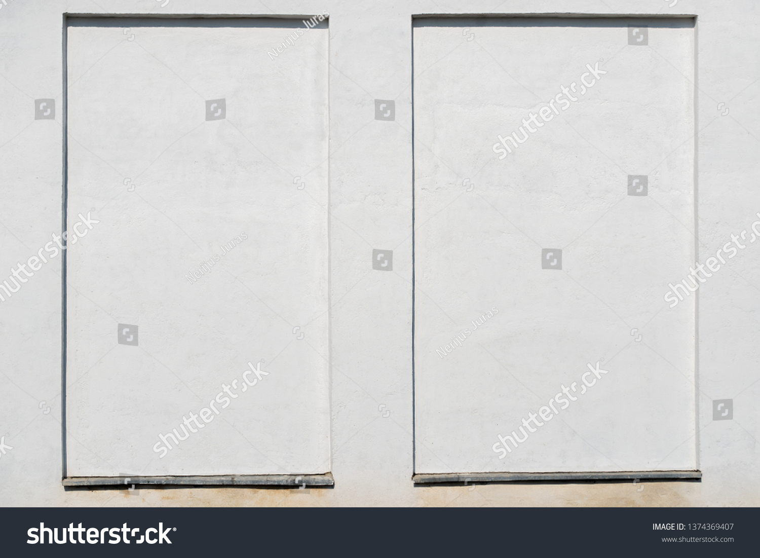 weathered white stucco wall with a stucco frame #1374369407