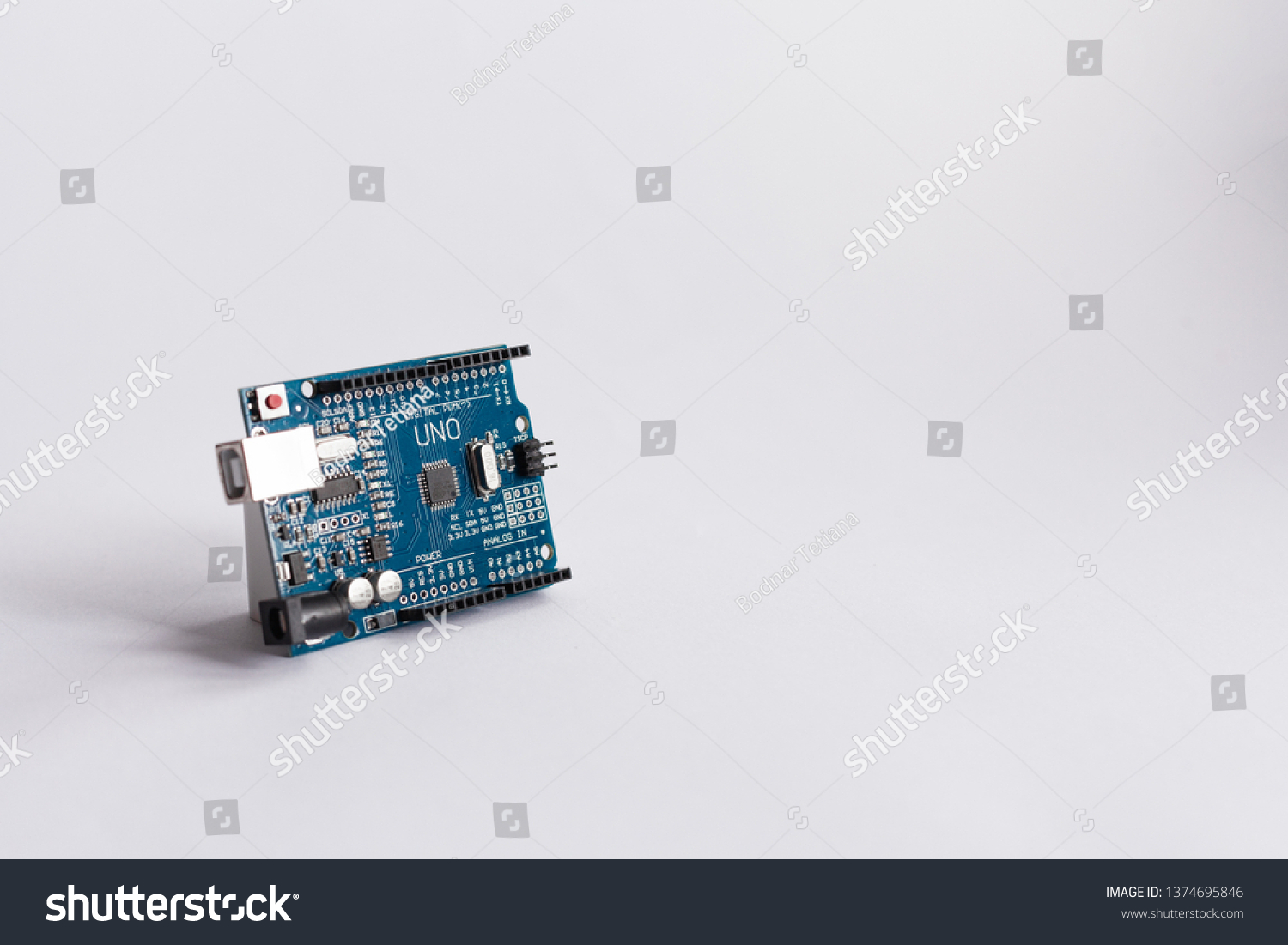 TERNOPIL/UKRAINE - APRIL 19, 2019: Arduino Uno. Micro controller. Technology. Electronic computing machine. High intelligence. science. White background. STEM, robotics. DIY. AI. Development platform #1374695846