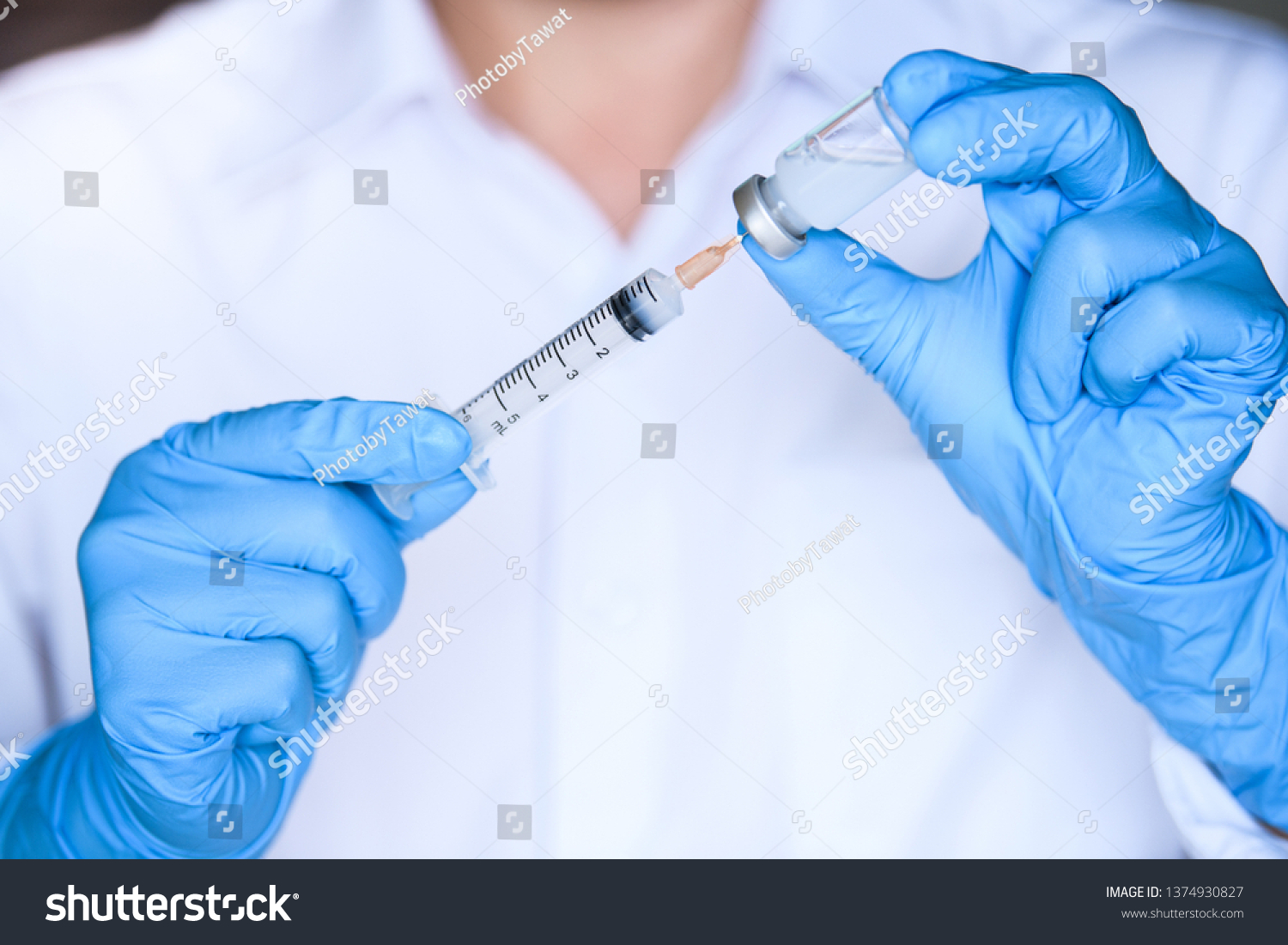 Doctor or scientist hand holding flu, mumps, measles, polio, rubella or hpv vaccine bottle and  syringe with needle for immunization, medical background, medicine and drug concept #1374930827
