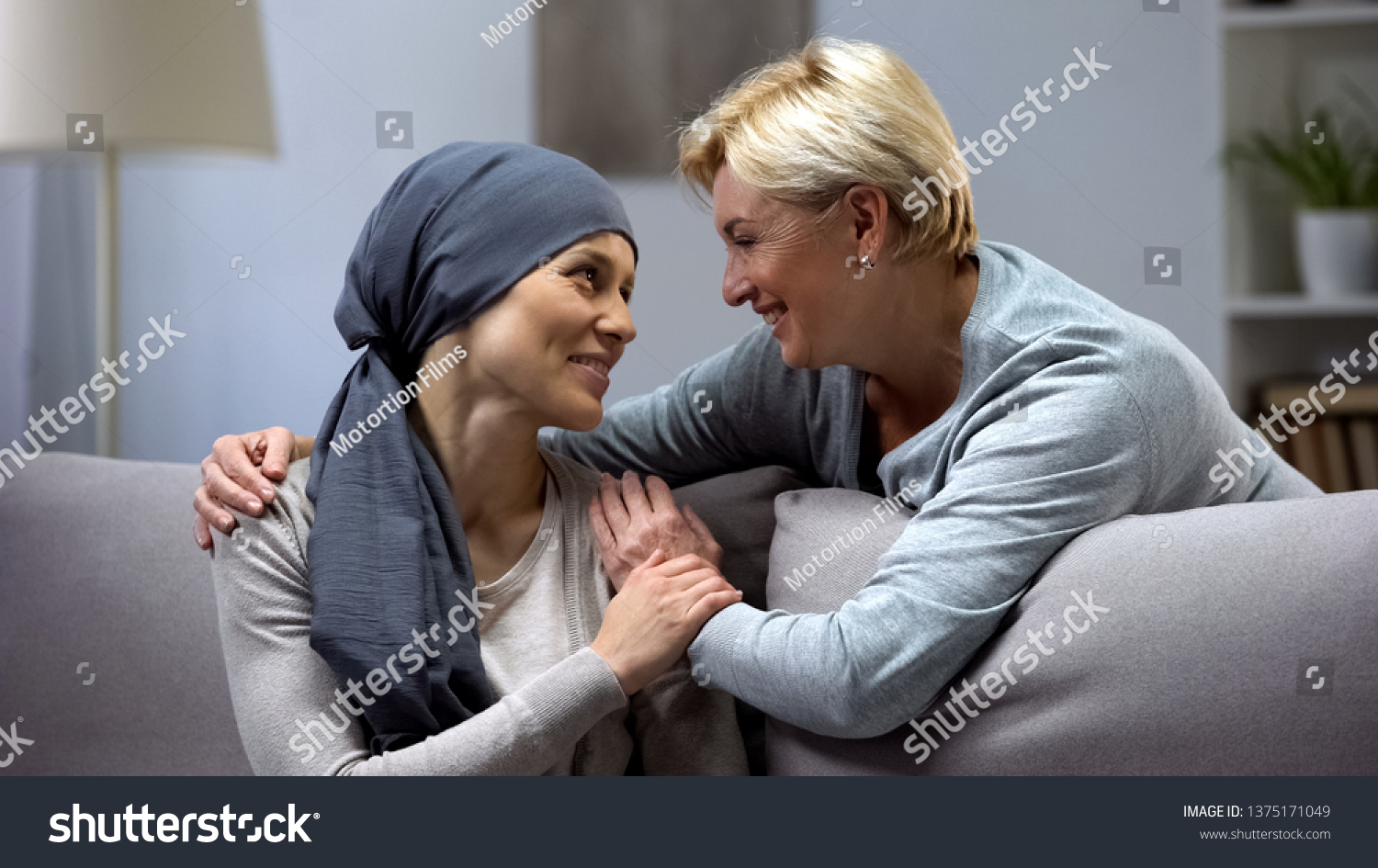 Mom supporting and hugging her daughter with cancer, visits in oncohospital #1375171049