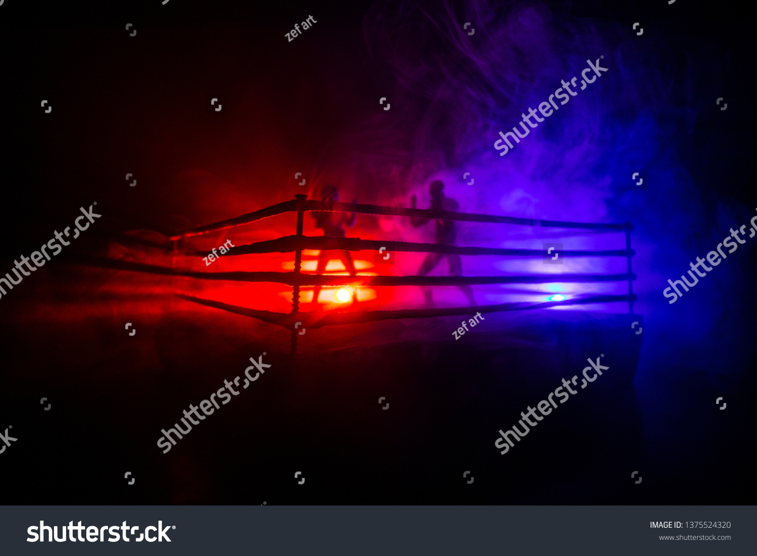 Man and woman boxing on the ring. Sport concept. Artwork decoration with toys on foggy toned dark background. #1375524320