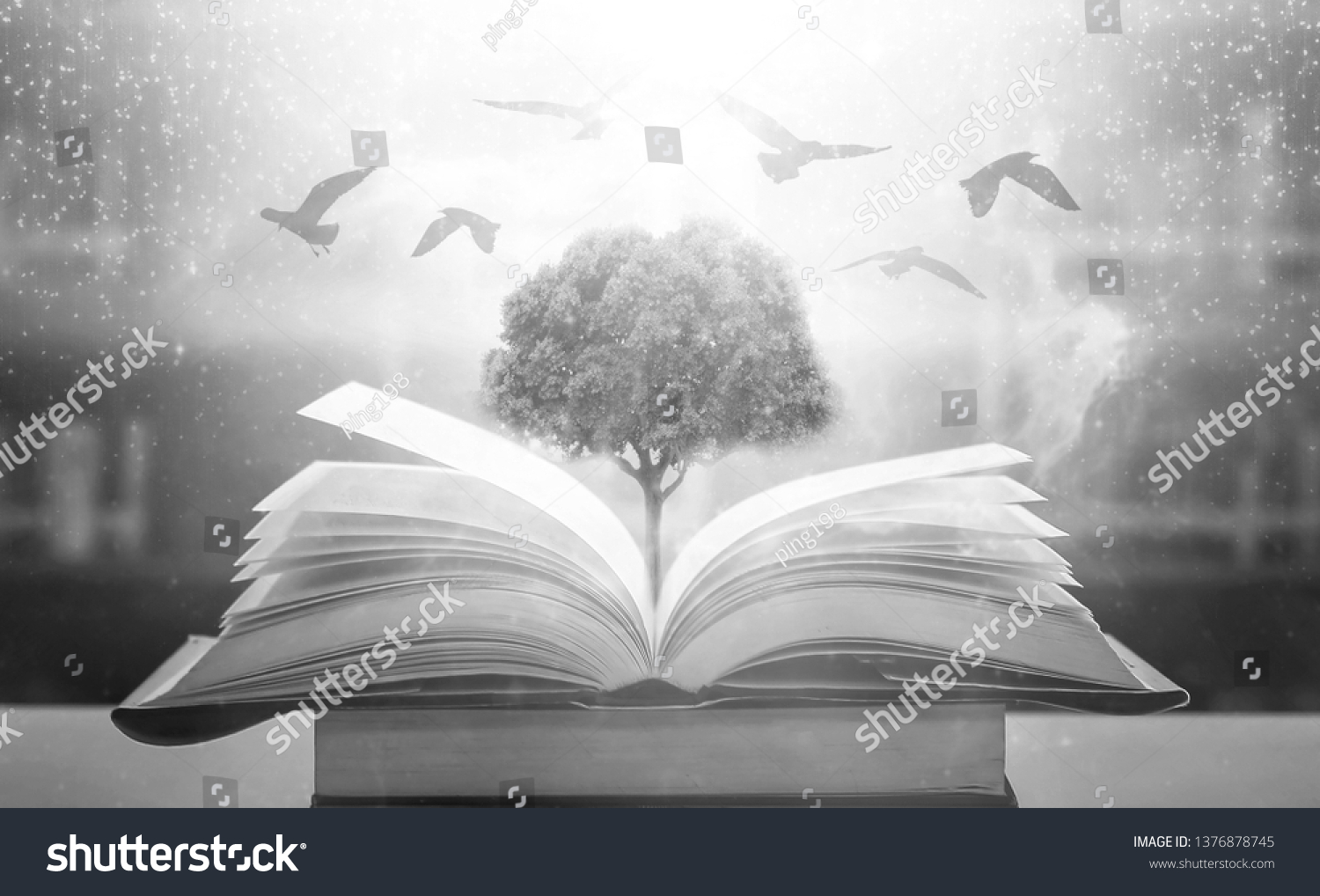 The concept of education by planting a tree of knowledge And birds that fly into the future In the opening of the old book in the library that contains the stack of textbooks that store the text  #1376878745