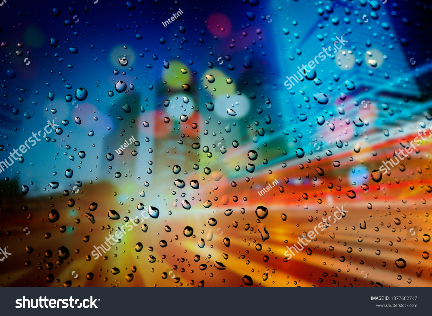  Rainy day. Raindrops on a blurred multicolored bokeh background #1377602747