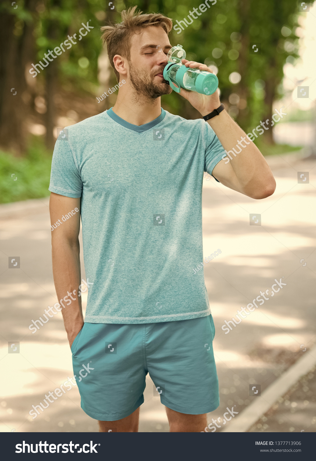 relax time. time to relax. relax time of healthy sportsman. athletic man has relax time in forest and drink water #1377713906