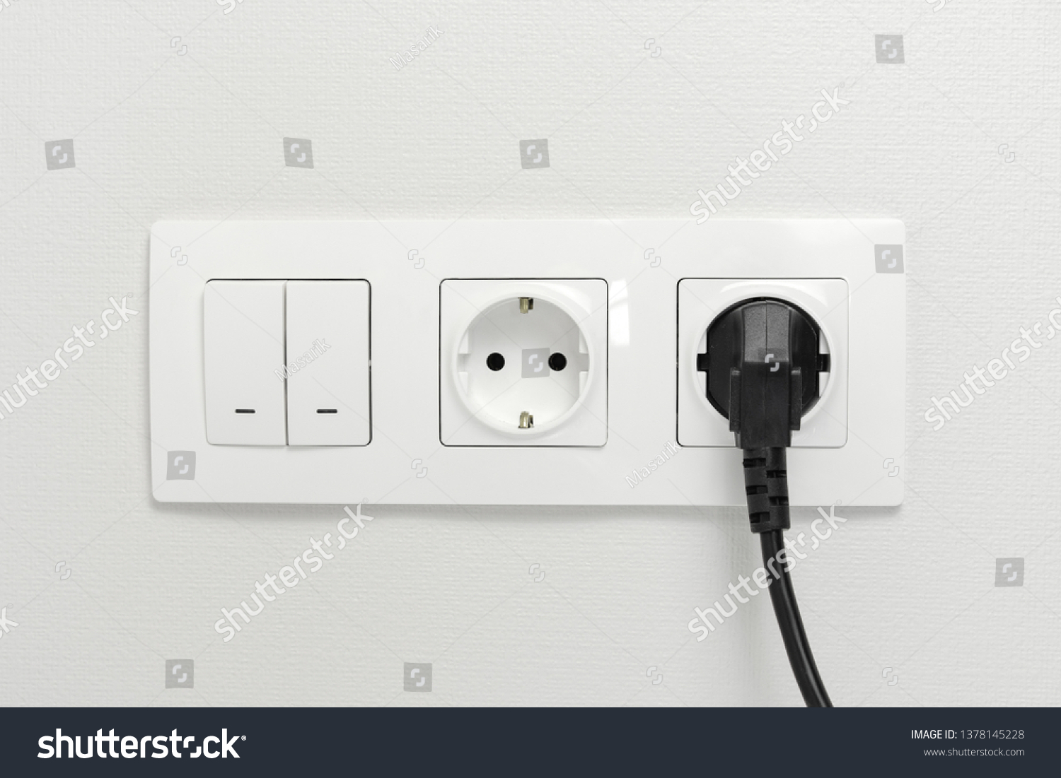 Electrical sockets on the wall with black connection plug and white switch.  #1378145228