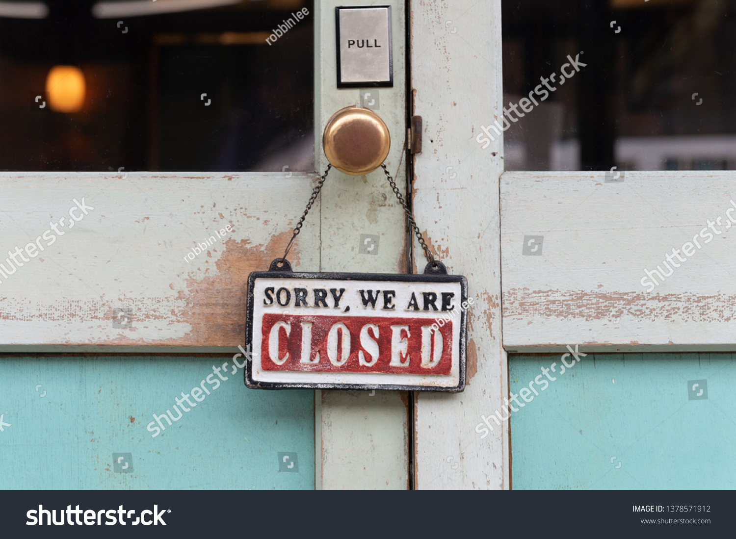 sorry we are closed sign hanging outside a restaurant, store, office or other #1378571912