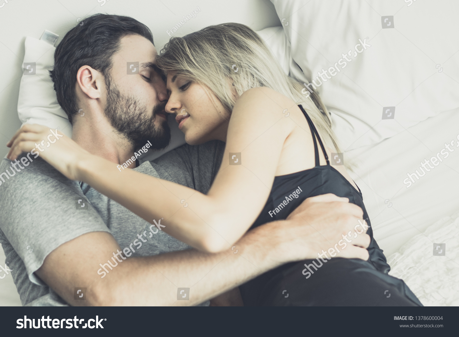 Loving happy couple in love smile and hug each other on the bed, in big bedroom, Love story concept #1378600004