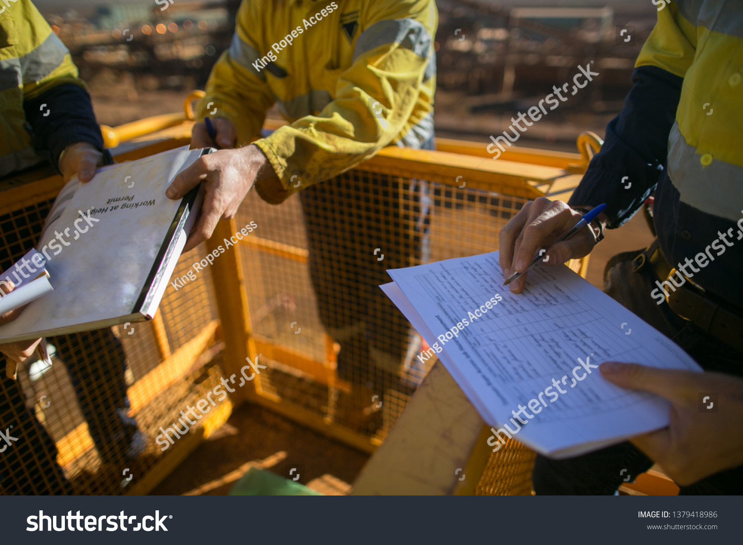 Trained supervisor safety auditor competent reviewing document issued sign approvals of working at height permit JSA risk assessment on site prior to performing high risk work mining construction site #1379418986
