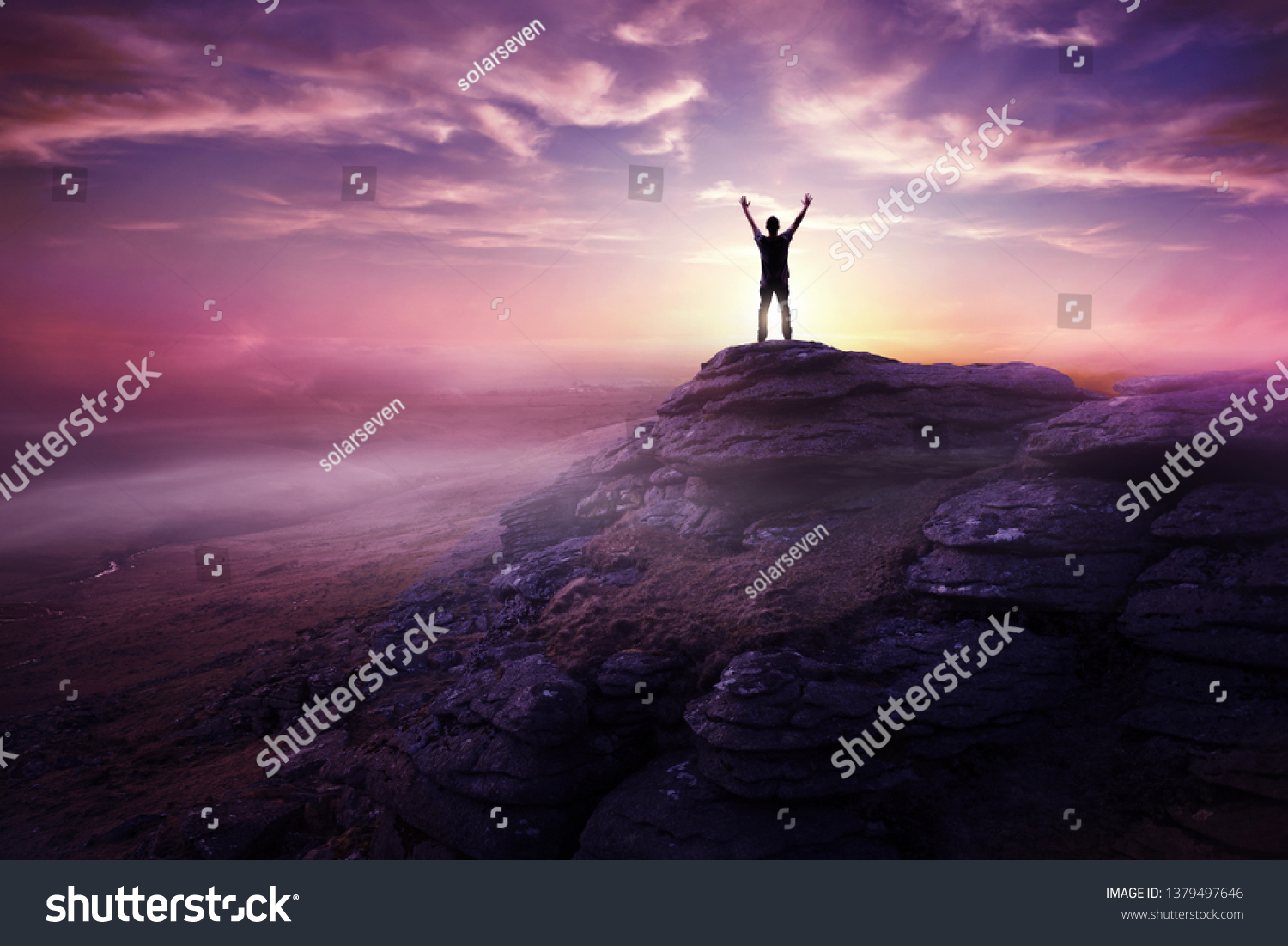 A man expressing freedom by reaching up to the sky as the sun sets in the distance. Hopes and dreams photo composite. #1379497646