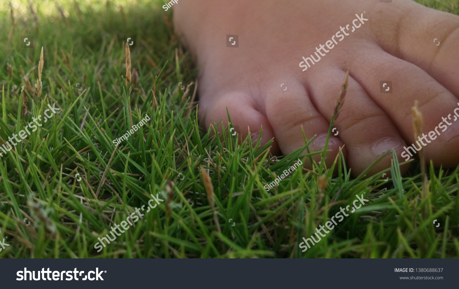 Tired feet resting on soft comfy grass.  Grass not trim or cut but naturally grow. #1380688637