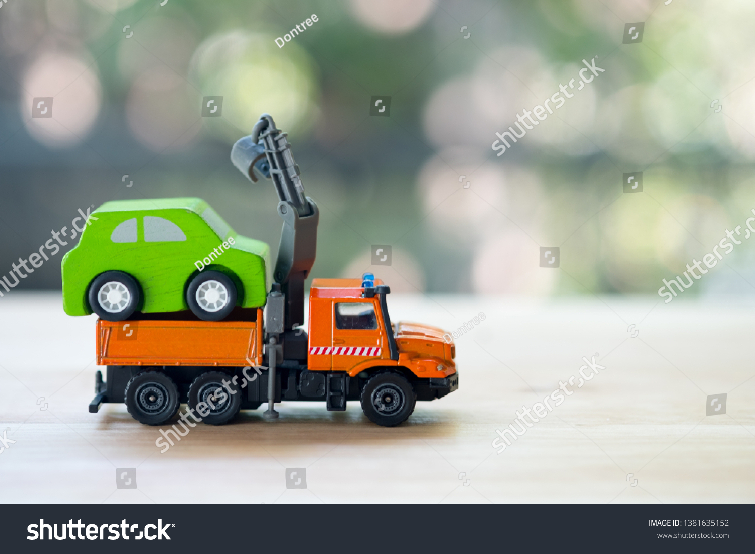 Miniature wooden car on truck transports. The truck transports service move and repair car #1381635152