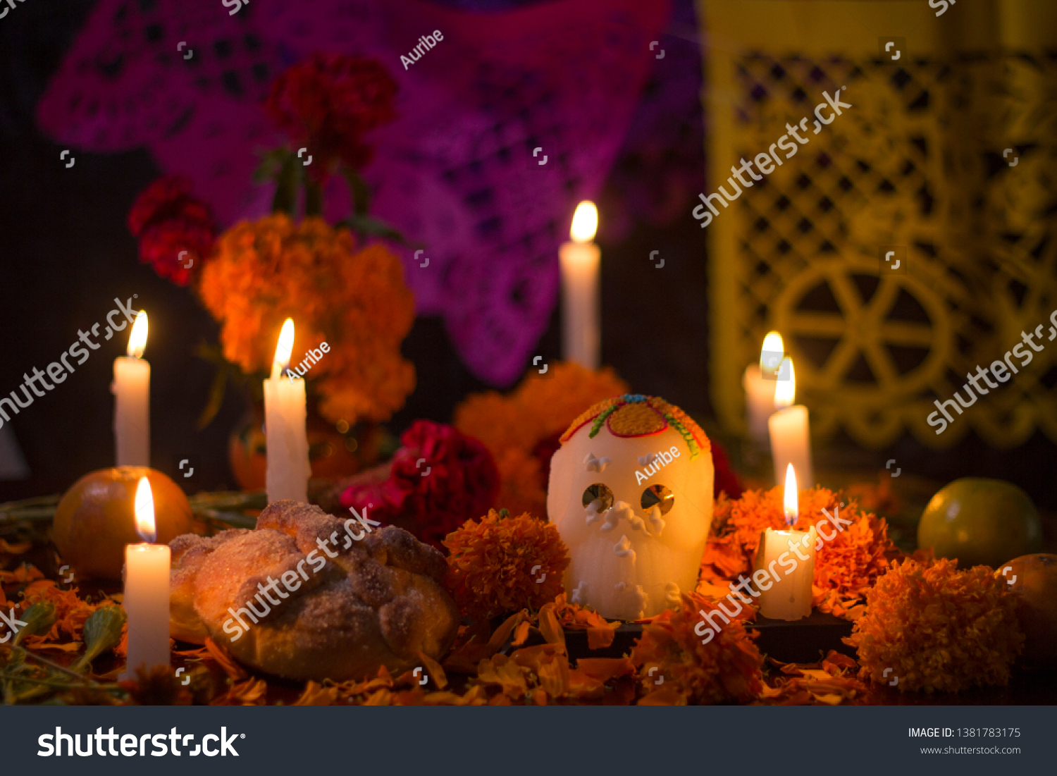 Day of the dead Sugar skull with candles, bread and flowers altar decoration at Janitzio, Michoacan #1381783175